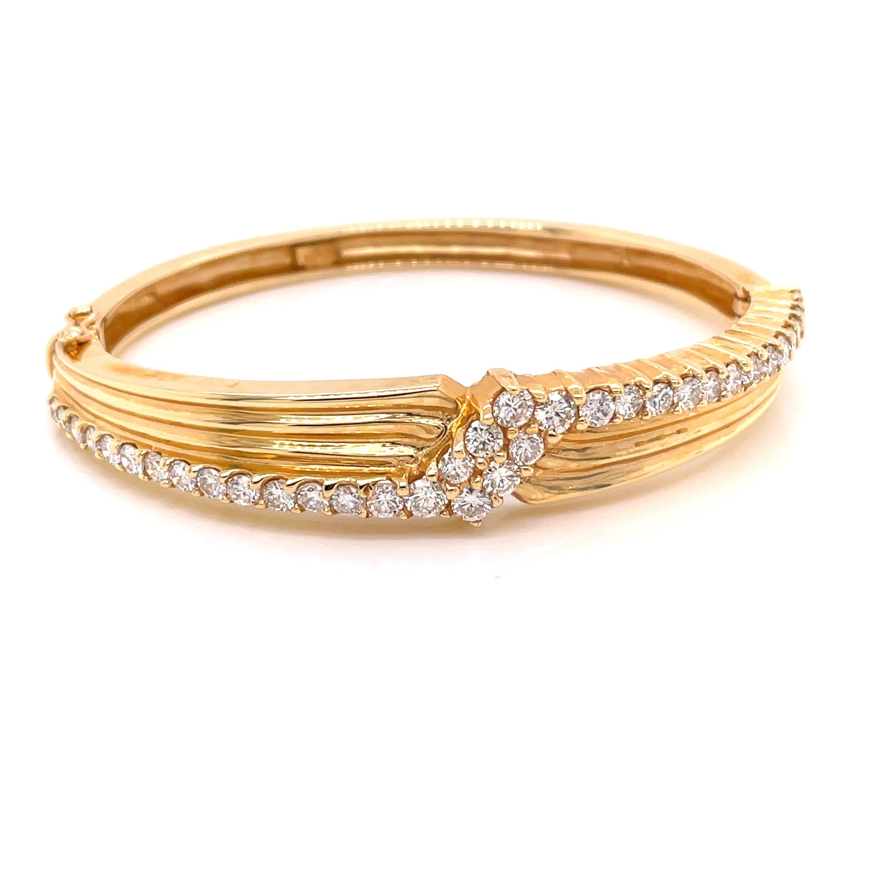 14K Yellow Gold Diamond Lightning Bolt Bangle Bracelet 2.50ct - The bangle is set with 36 round brilliant diamonds weighing 2.50ct with G - H color and VS2 - SI1 clarity. The width of the bangle is 11mm on top and tapers to 5mm on the bottom. The