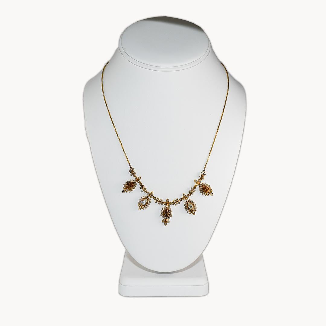 Diamond necklace set in 14k yellow gold.
Stamped 14k and weighs 19.4 grams.
There are five pear shape diamonds, approximately .35 carats each for a total of 1.75 carats.
Three of the diamonds are a natural cognac color, and two are i to j color, si