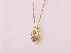 Collana con ciondolo a forma di cuore aperto con diamanti in oro giallo 14 carati