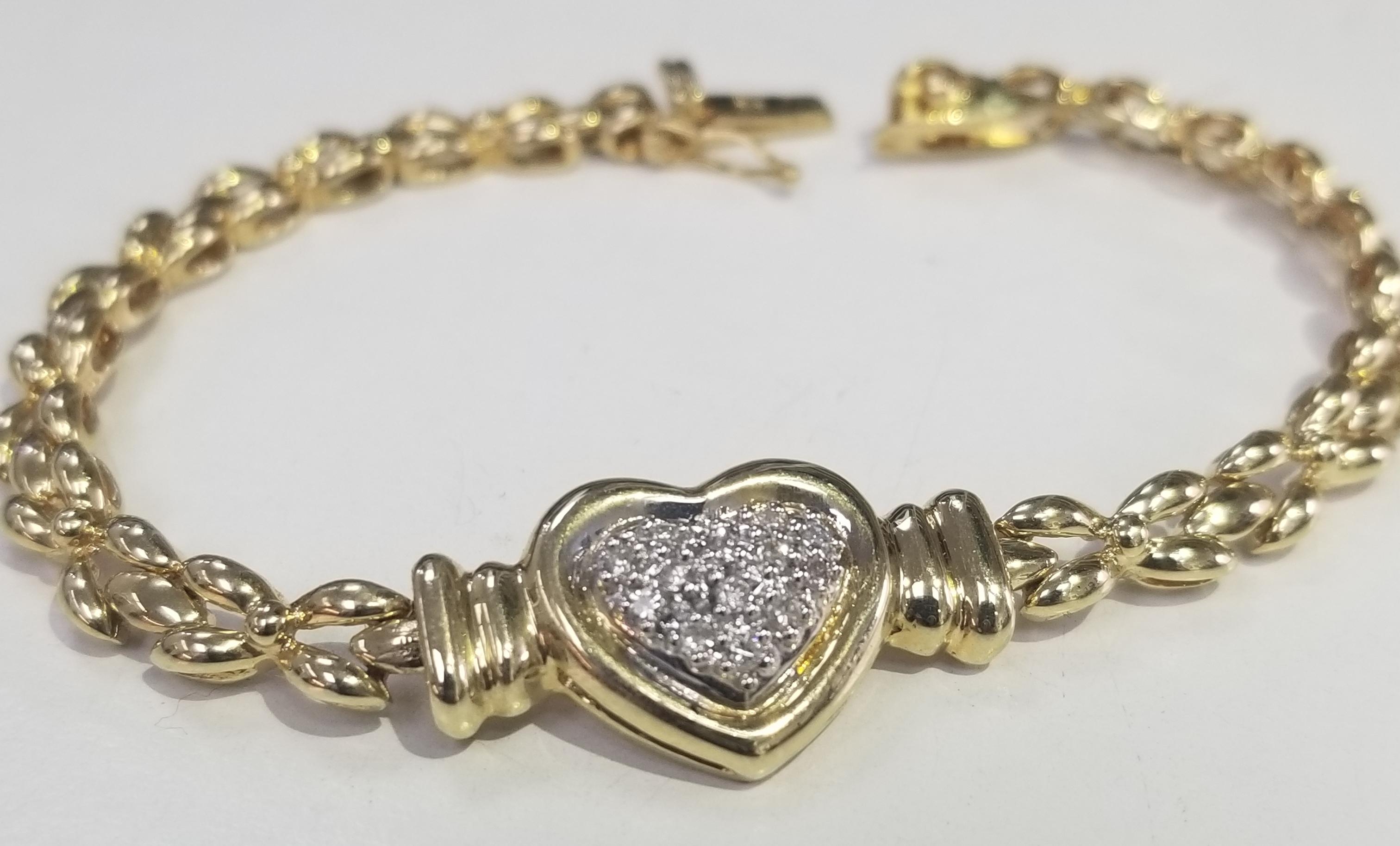 14k yellow gold diamond Heart bracelet on link bracelet.
Product Details
    Metal: 14K YELLOW GOLD
    Measurements :
        Width: 14MM
        Length 7 inches
Specifications:
    main stone: ROUND CUT DIAMONDS
    diamonds: 16 PCS
    carat