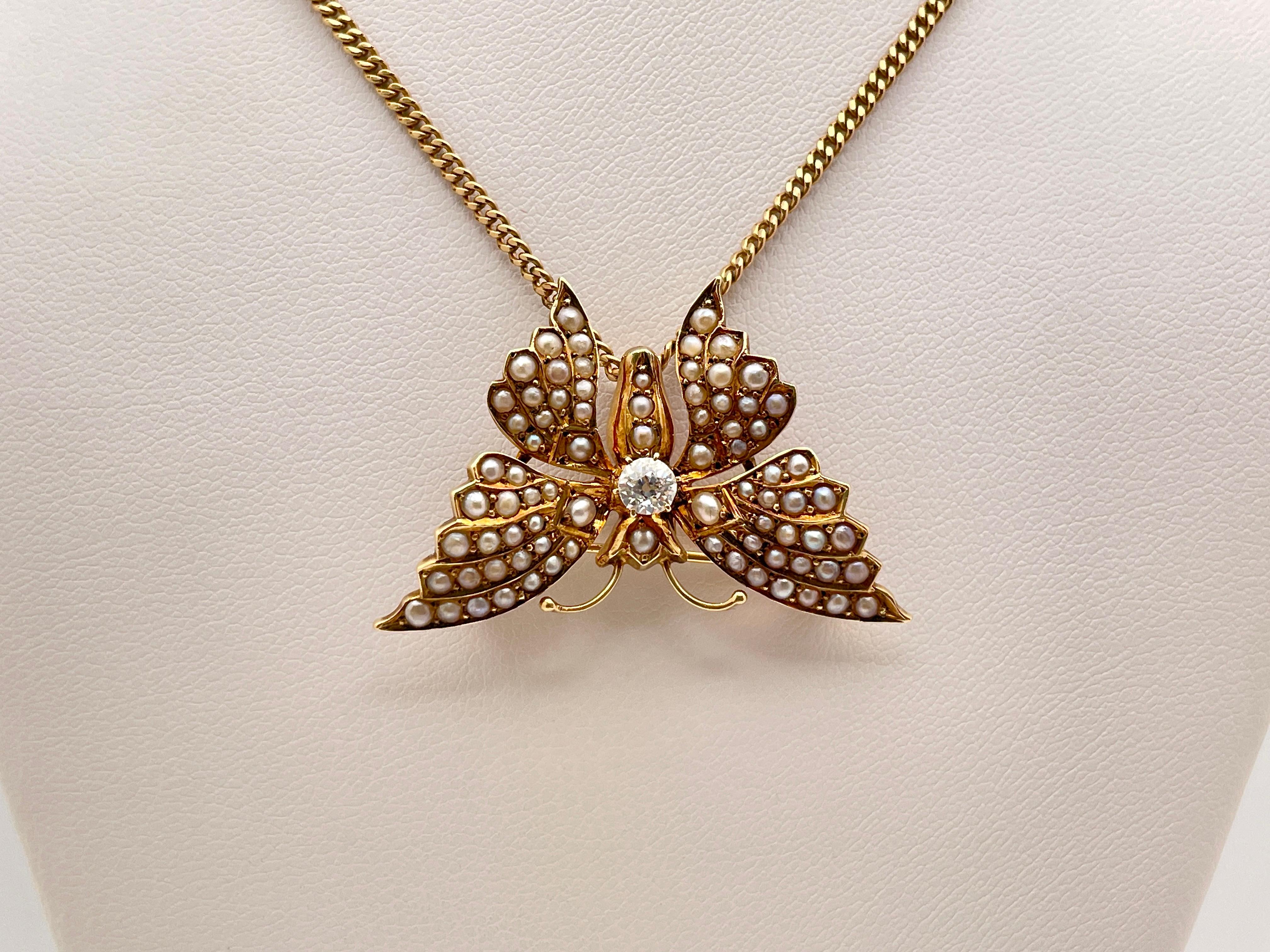 An original Victorian 14K yellow gold diamond and pearl butterfly brooch (pin/pendant). Decorated with round white pearls and centered with an old European cut diamond weighing approximately 0.40 CT, E color, VS1 clarity. The pin on the back is 10K