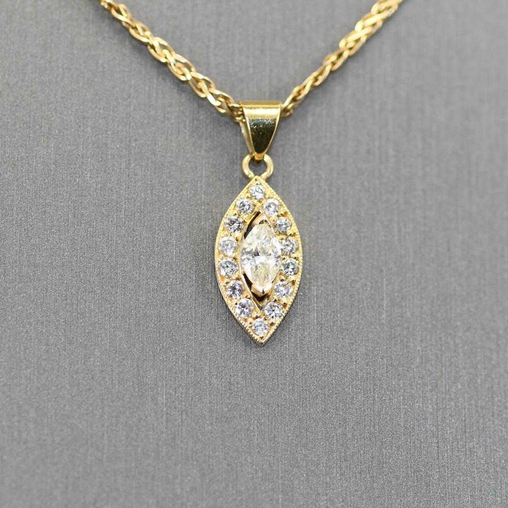 14k Yellow Gold Wheat Chain Necklace with a Diamond Pendant .63tdw.
The Center Stone Is an .35ct Marquise cut. J-K Color , I1 Clarity. 
The smaller surrounding Diamonds are Round Brilliant Cuts.
SI1-SI2, G-H-I Color. 
The chain measures 20in Long x