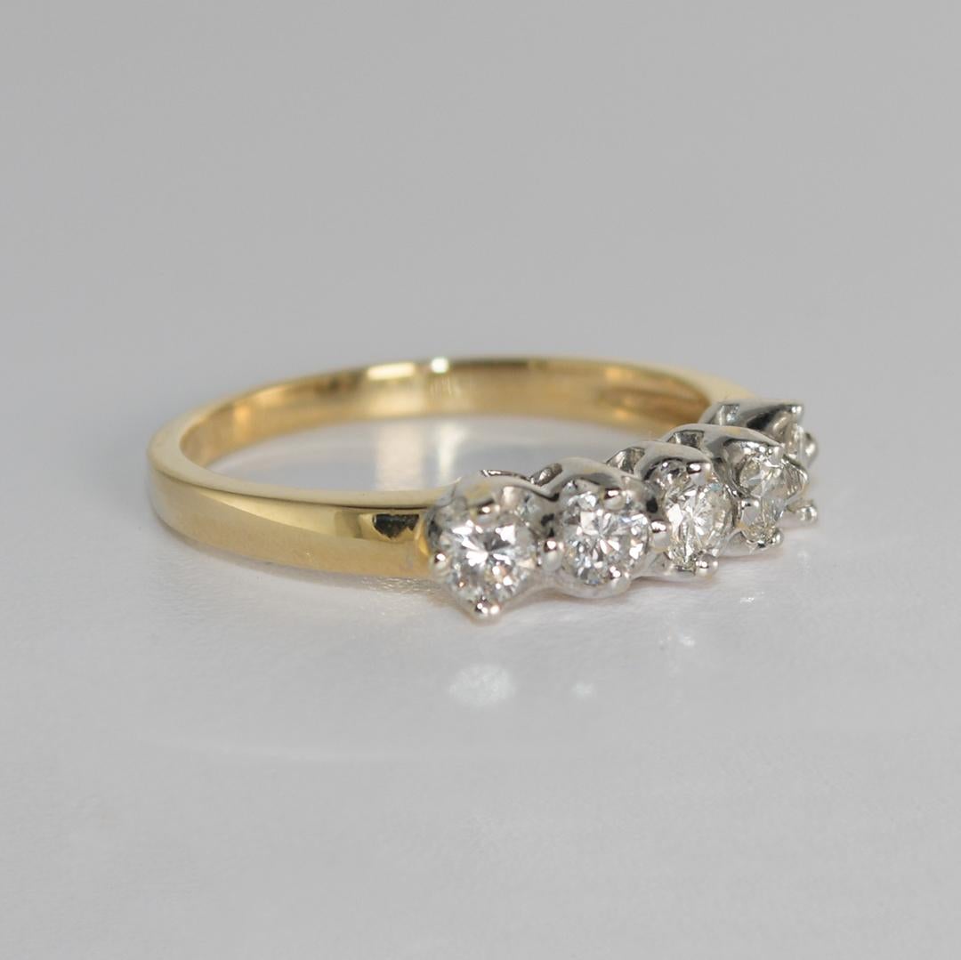 This beautiful 14 karat yellow gold ring weighs 2.40 grams.
It contains five round brilliant diamonds, with a total carat weight of 0.55 and a VS to SI1 clarity.
The ring is a size 6.2 and in excellent condition.