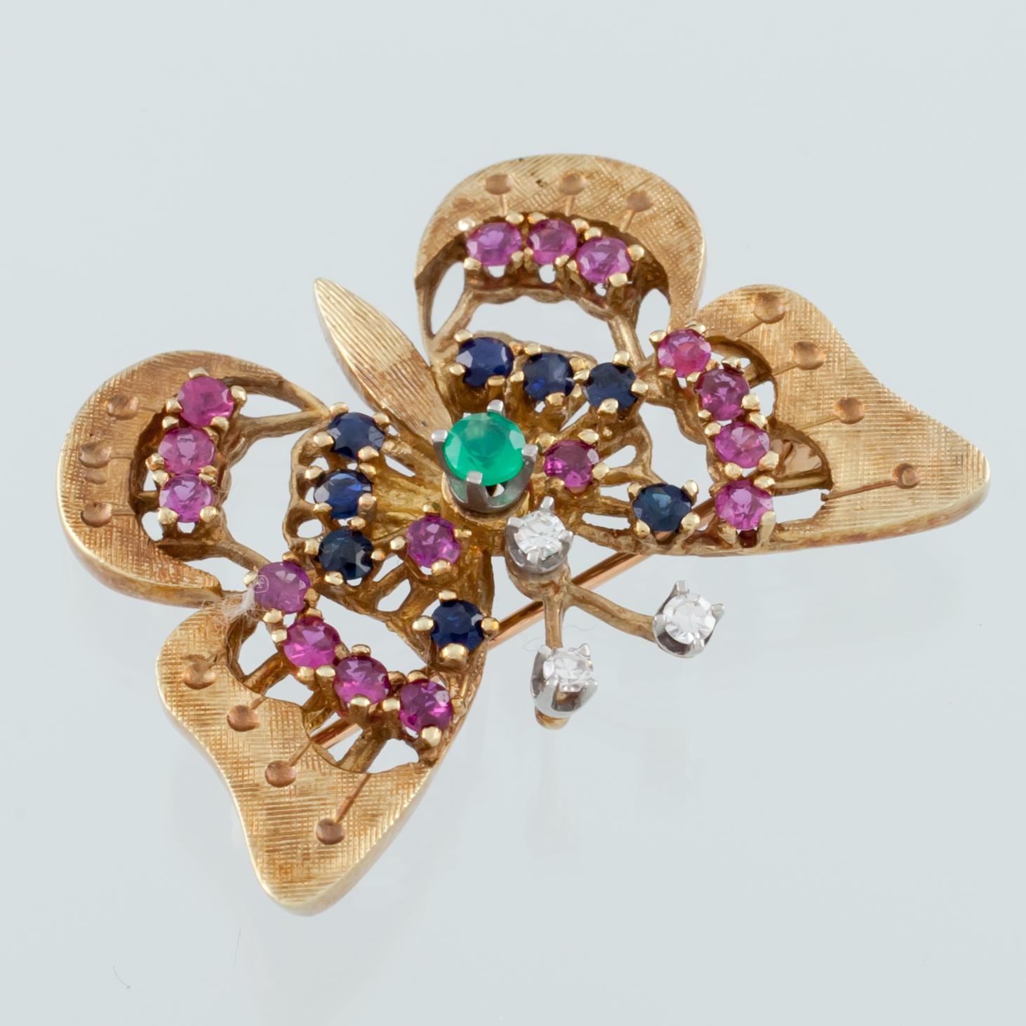 Gorgeous Butterfly Brooch
Features Prong Set Emerald, Sapphires, and Rubies in Radial Pattern from Center
Diamond Accents on Antennae
33 mm Wide
23 mm Long
Total Mass = 7.7 grams
Reverse Hallmarked 