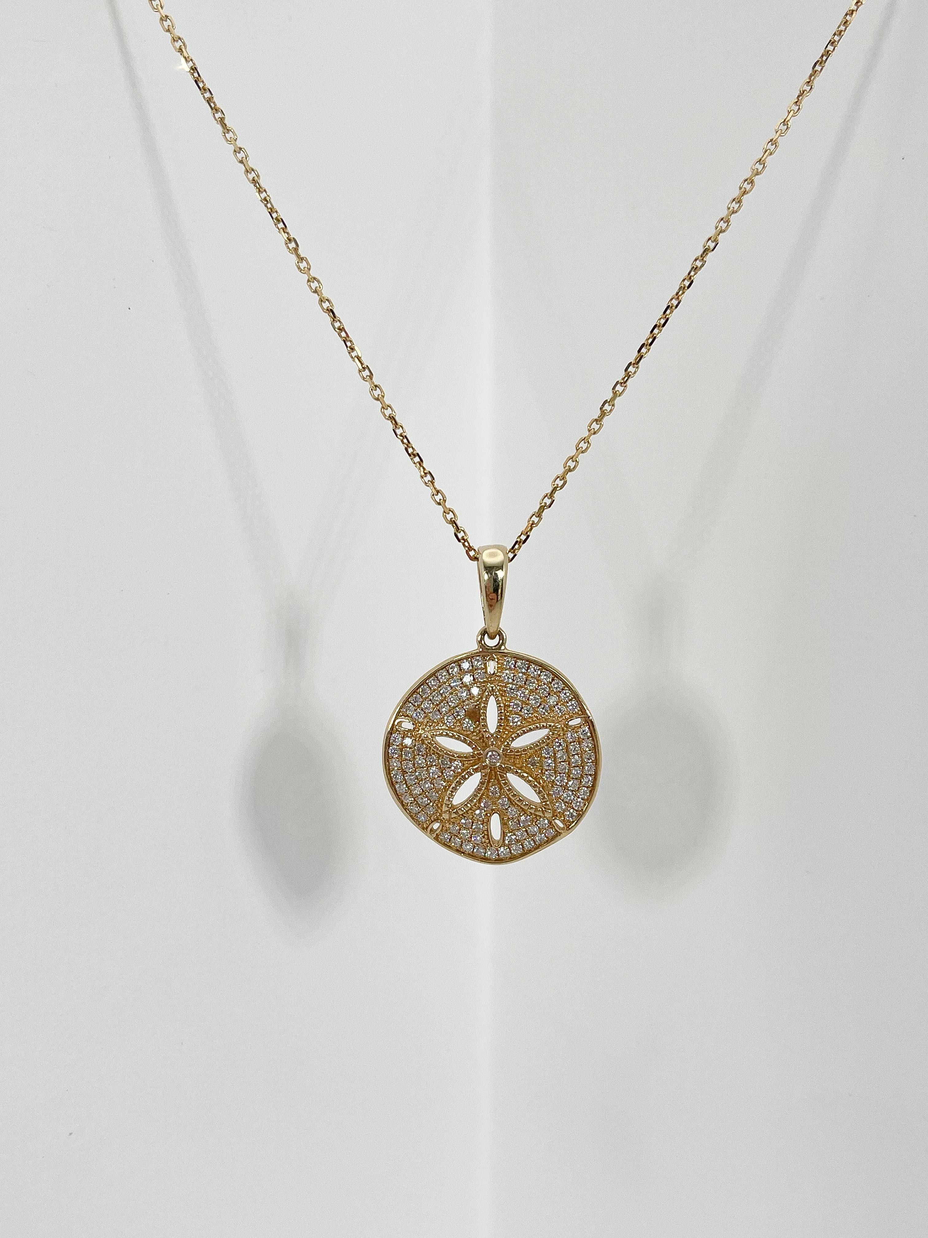 14k yellow gold diamond sand dollar pendant necklace. Pendant comes on an 18 inch diamond cut cable chain, all diamonds in the pendant are round, the sand dollar has a diameter of 21.3mm, has a lobster clasp to open and close, and the necklace has a