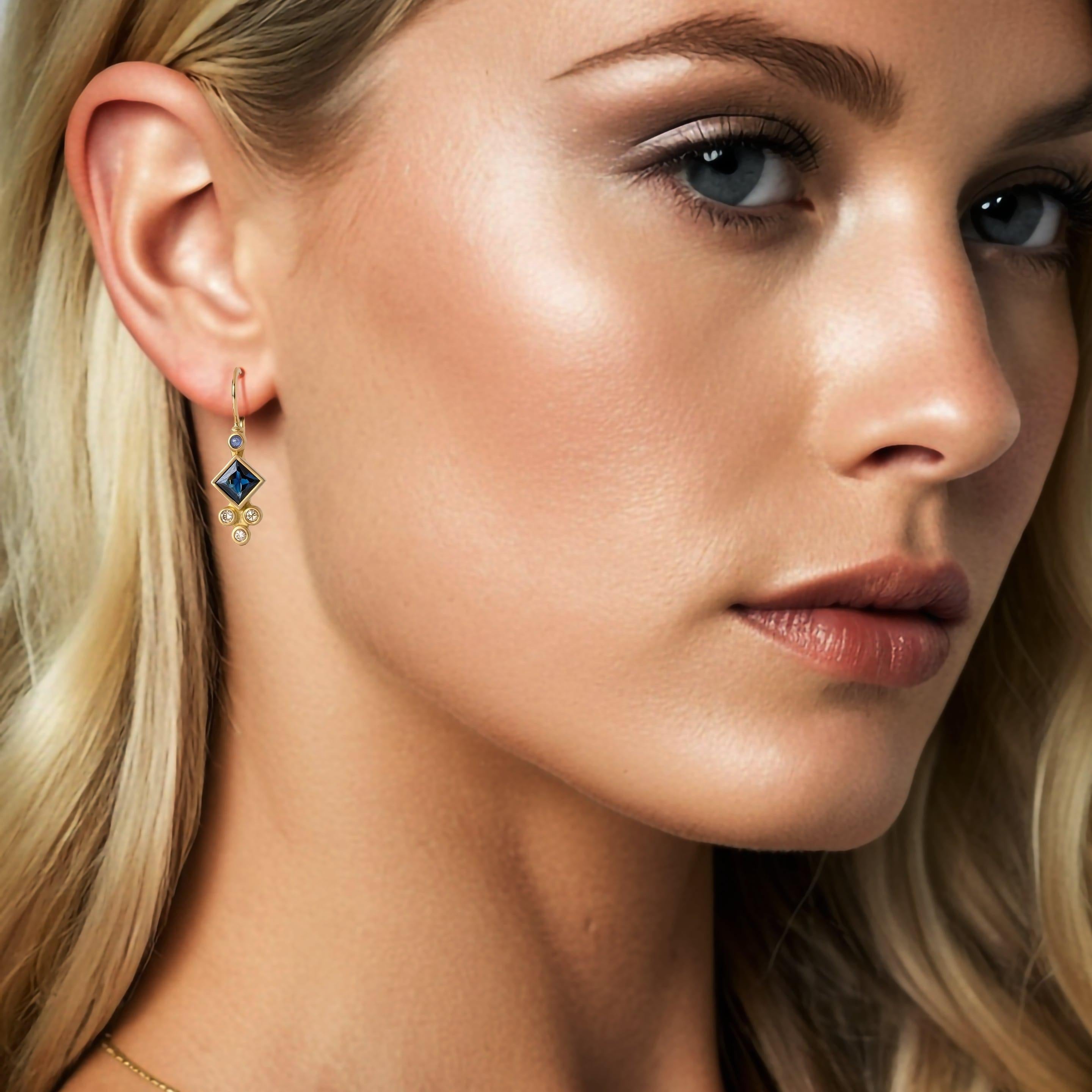 Elegant and timeless, this Princess Cut Sapphire Diamond 14K Yellow Gold Drop Earrings showcases a vibrant, richly hued emerald at its center, set in a beautifully crafted gold band. The natural green tones of the emerald, symbolizing renewal and