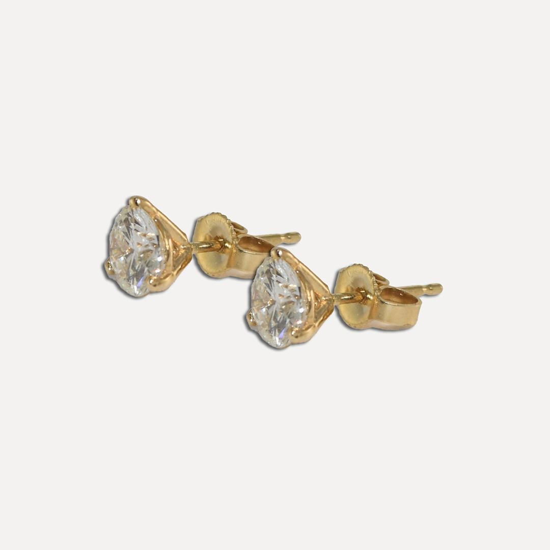 Diamond stud earrings in 14k yellow gold settings.
The settings are stamped 14k and the gross weight is 1.1 grams.
The diamonds are round brilliant cuts, i to j color, Si to i1 clarity, good cuts. 
The total diamond weight is 1.58 carats.