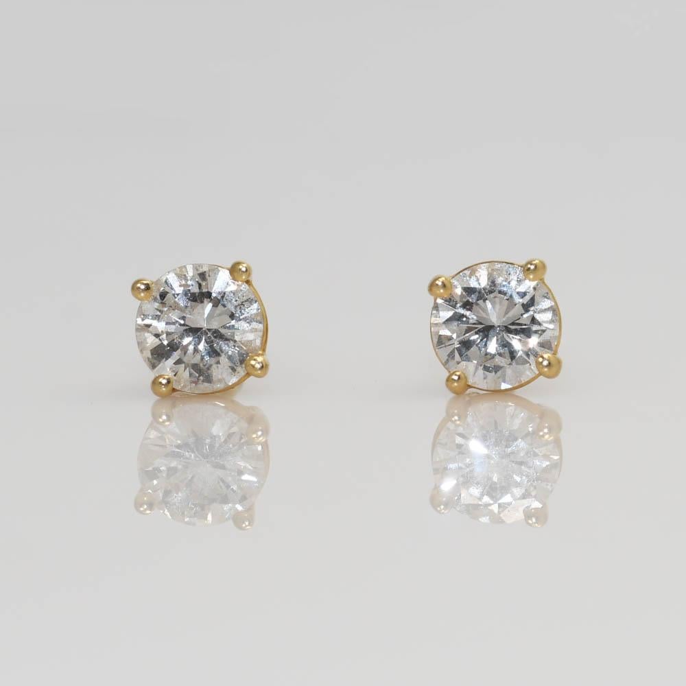 Diamond stud earrings in 14k yellow gold settings.
The diamonds are round brilliant cuts, .40 total carats, H to i color range, i1 clarity, good cuts.
The settings have posts with friction backs for pierced ears.
Excellent condition.