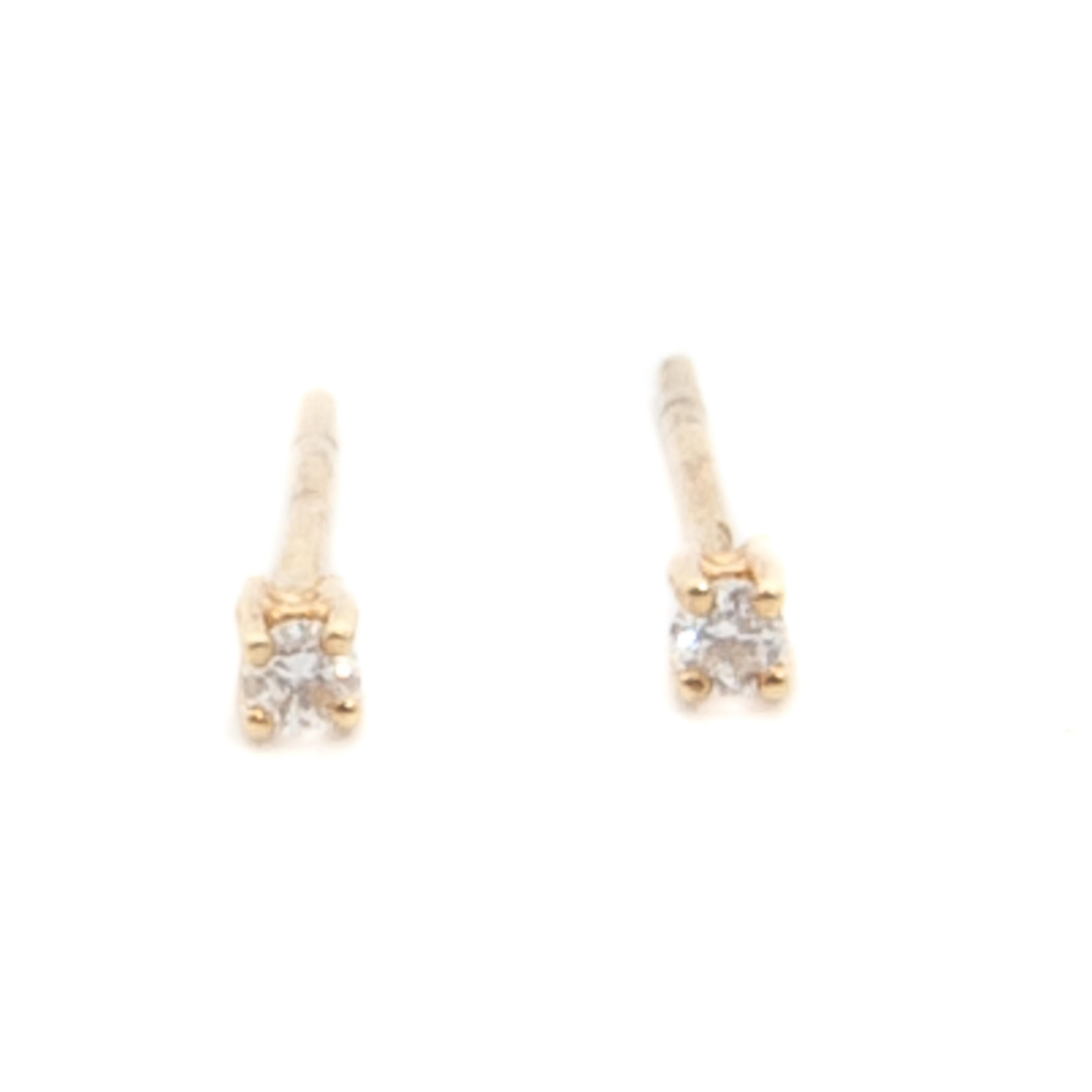 These beautiful solitaire stud earrings are made of 14 karat yellow gold. Each earring is set with a brilliant cut diamond, the diamonds are approximately 0.10 carat in total. The diamonds are prong set in a 14 karat gold frame. The earrings are set