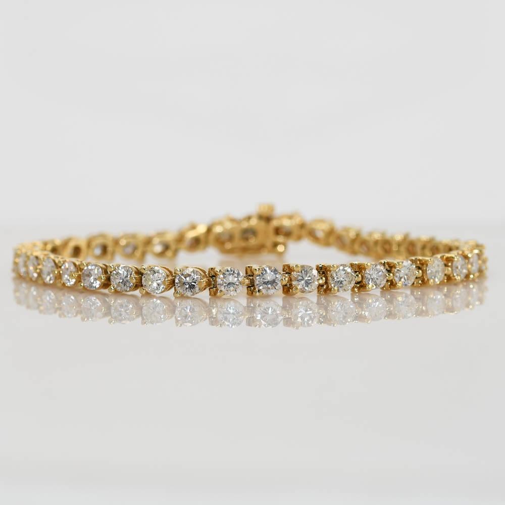 14k yellow gold diamond tennis bracelet.
Stamped 14k and weighs 14.4 grams gross weight.
There are 37 round brilliant cut diamonds, G, H, I color range, Si clarity, good cuts.
Approximately, 6.50 total carats.
The bracelet measures 7 inches long and