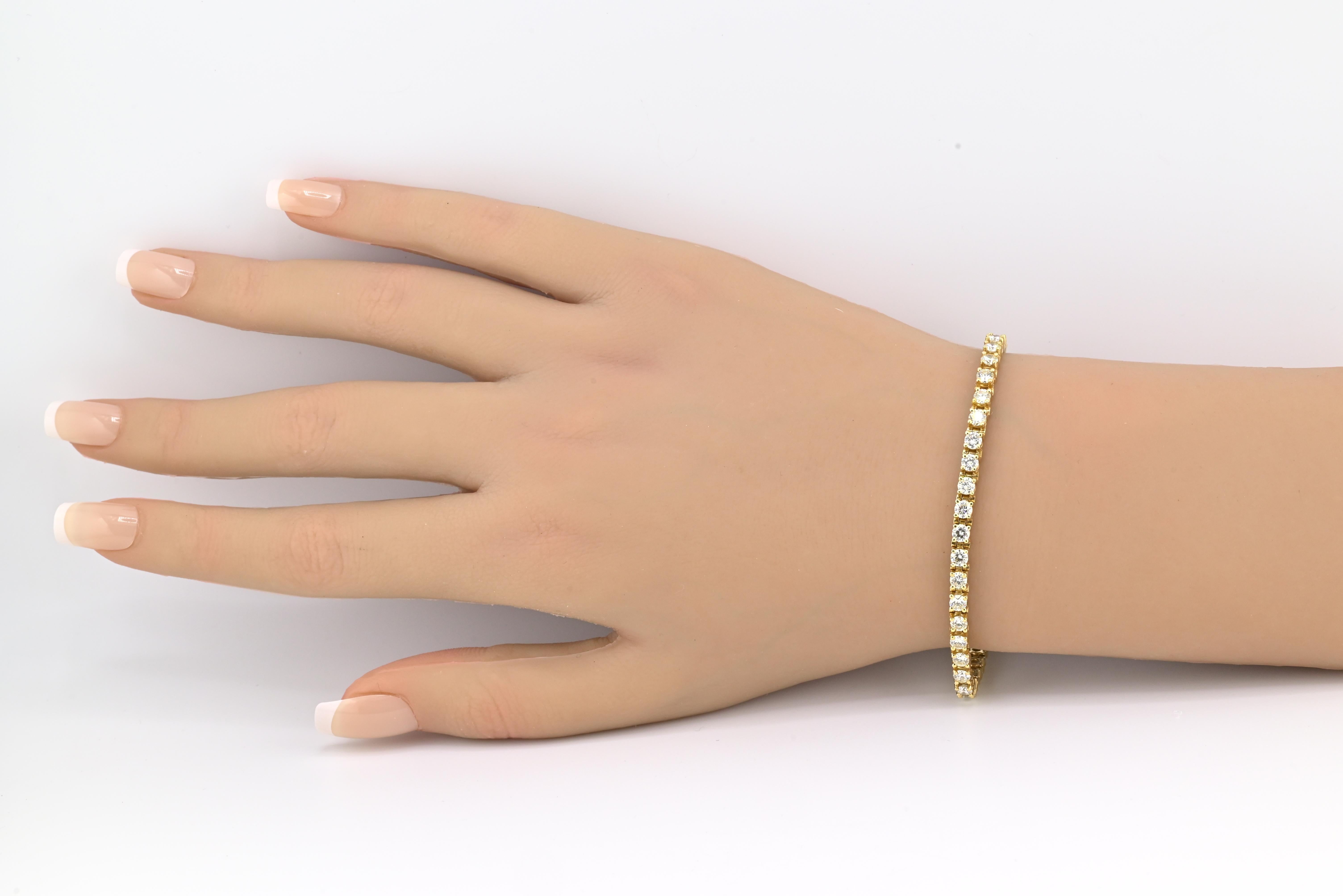 This stunning 14K yellow gold diamond tennis bracelet offers timeless elegance and exceptional craftsmanship. The piece showcases approximately 5.00 carats total weight of natural round brilliant cut diamonds, each hand-selected for quality and