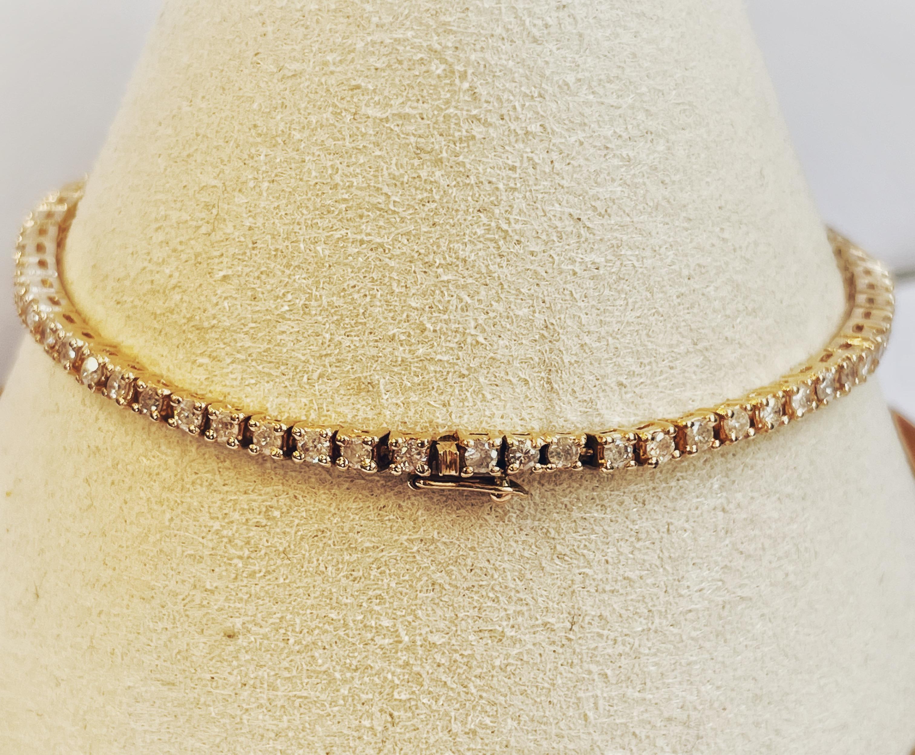 14K Yellow Gold tennis bracelet with 66 round brilliant diamonds measuring 2mm each. This bracelet is 7 inches in length and weighs a total of 4.91dwt. Classic bracelet for every occasion. This bracelet is as is and cannot be customized or