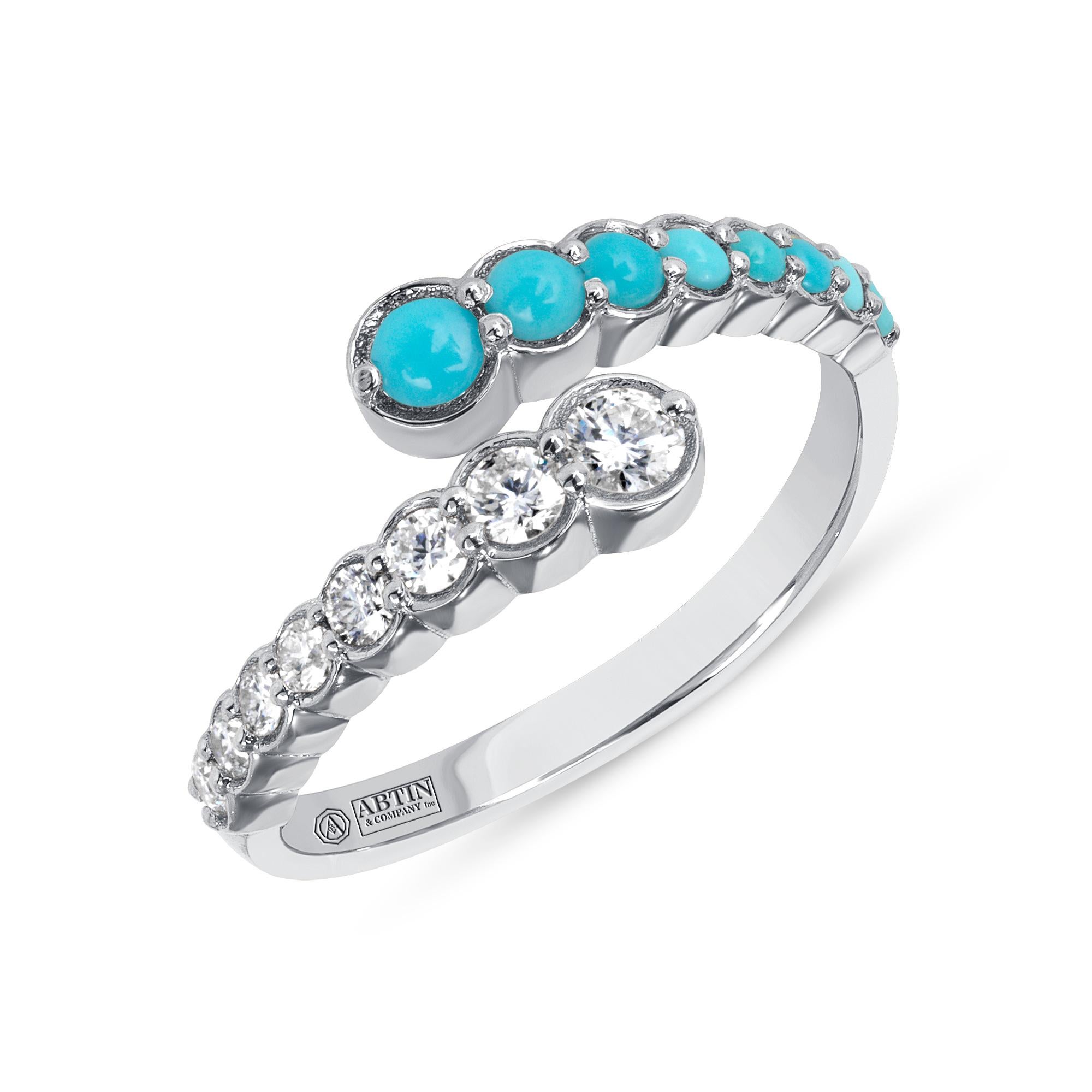 Crafted in 14K gold this ring features clean and contemporary lines. This modern and stylish open bypass ring is set with mesmerizing round-cut 
diamonds and genuine Turquoise. Stack it with your stacking rings or wear it solo to elevate any