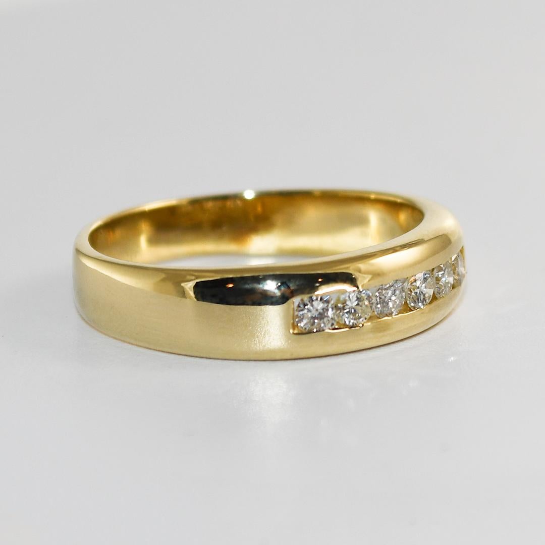 Men's 14k yellow gold and diamond wedding band.
Stamped 14k and weighs 6.6 grams.
The diamonds are round brilliant cuts, .50 total carats, H to I color, and SI clarity.
The ring measures 6mm wide at the top.
The ring size is 12 and can be sized down