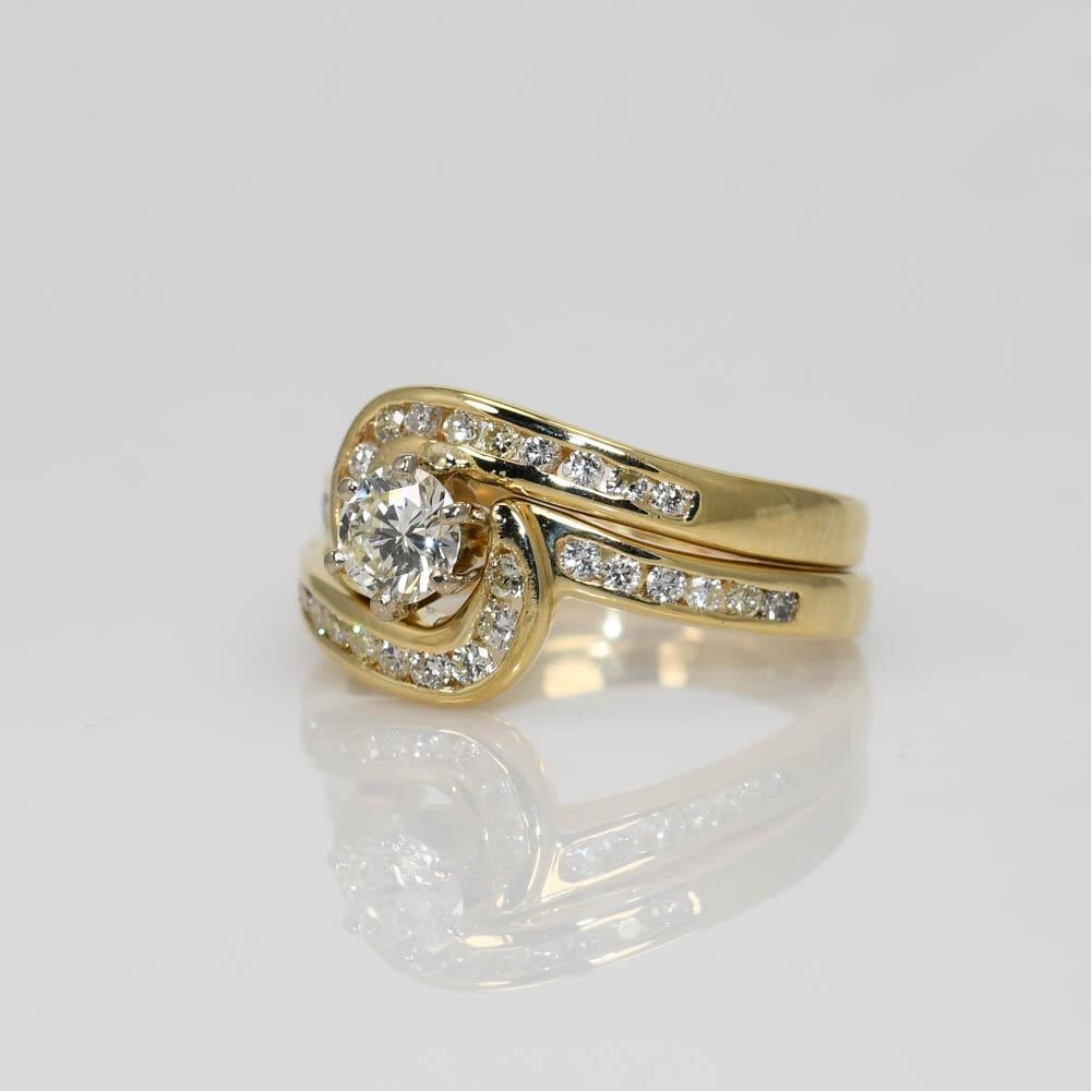 Ladies diamond wedding ring in 14k yellow gold.
Stamped 14k and weighs 6.5 grams.
The center diamond is a .50 carat round brilliant cut, J to K color, VS2, good cut.
The side diamonds are round brilliant cuts, .35 carats total weight, j to k color,