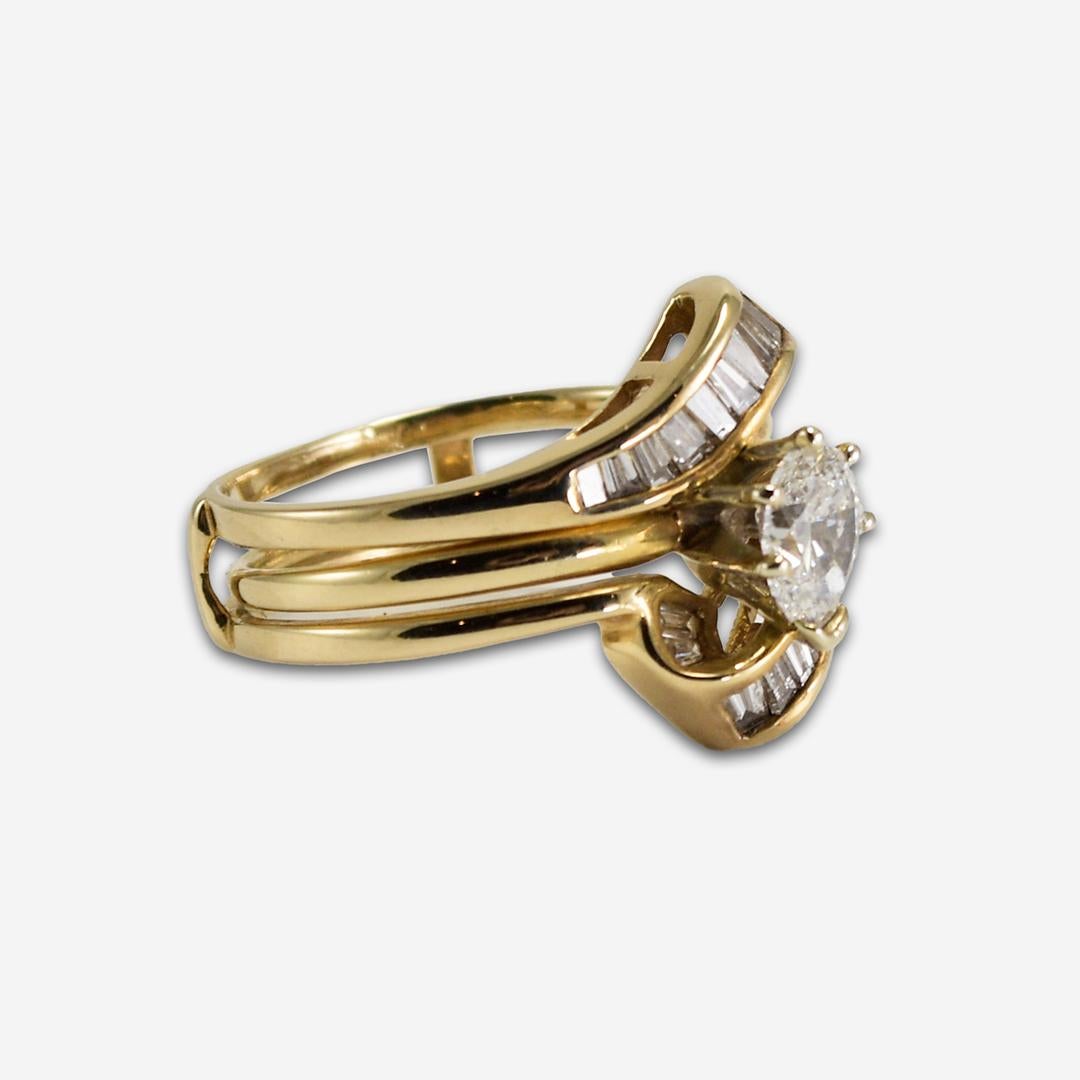 Diamond ring set in 14k yellow gold. Stamped 14k and weighs 5.2 grams.
The center diamond is a 0.58ct pear-shaped diamond H-I-J color & SI2-I1 clarity in a Tiffany-style setting.
The Ring guard is set with 20 baguette diamonds, .50 carats total