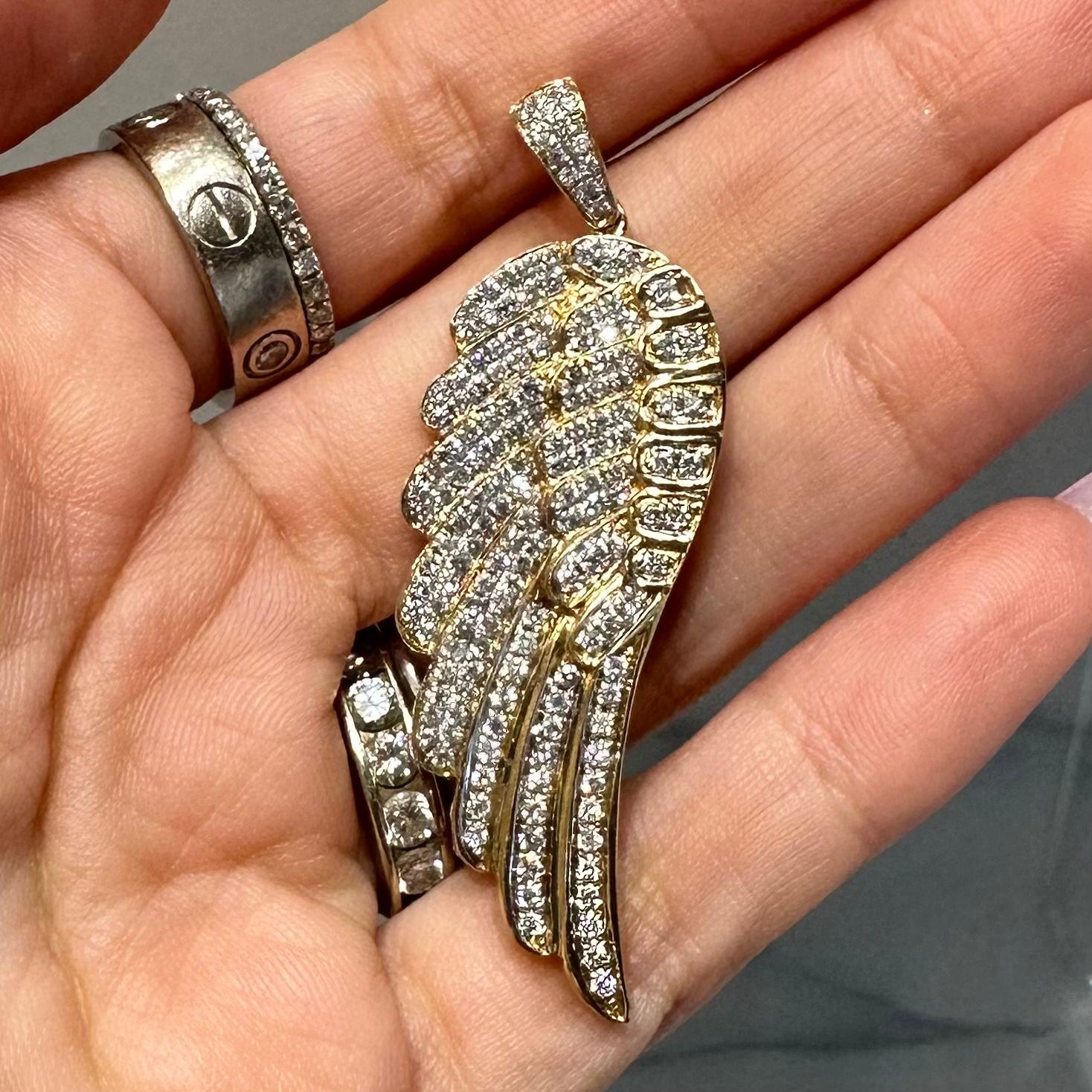 Style: Diamond Wing Pendant

Metal: Yellow Gold

Metal Purity: 14K

Stones: 140 Diamonds

Diamond Color: G-H​​​​​​​

Diamond Clarity: VS2

Total Carat Weight (ct): 1.96 ct

Total Item Weight (g): 12. g 

Dimensions: 5.5 in x 1.2 in (including