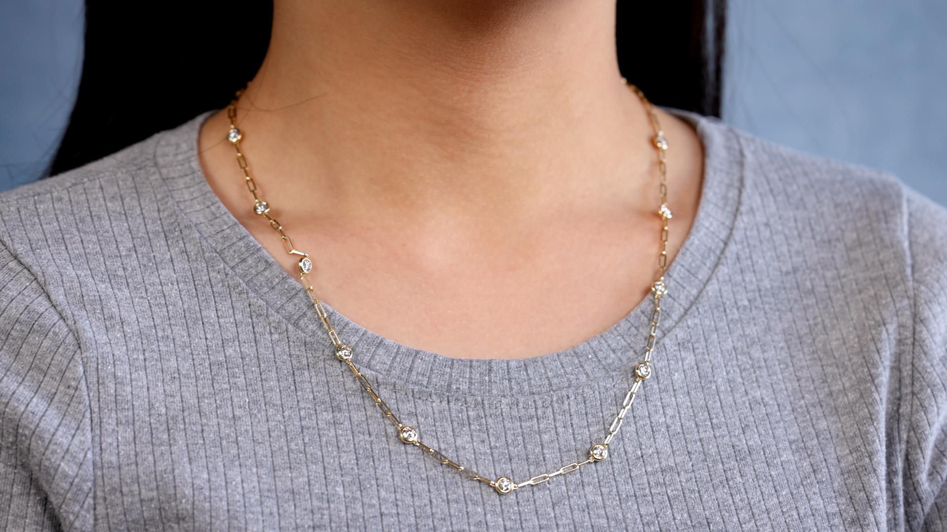 One 14k Yellow Gold Diamonds By The Yard Paperclip Necklace. Featuring 11 round brilliant cut diamonds with a total weight of 2.00 carats, graded H-I color, SI clarity. Crafted in 14 karat yellow gold with purity mark and maker’s mark. Circa 2023.