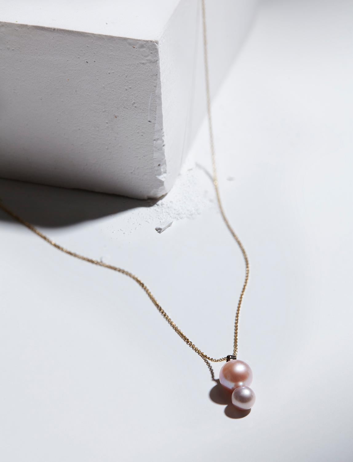 Elegant, feminine, unexpected.  This 14k yellow gold pearl necklace is a delicate twist on a classic pearl pendant necklace.  We love the way the luminescent rosy pearls sit together, their slightly different colors complementing each other and