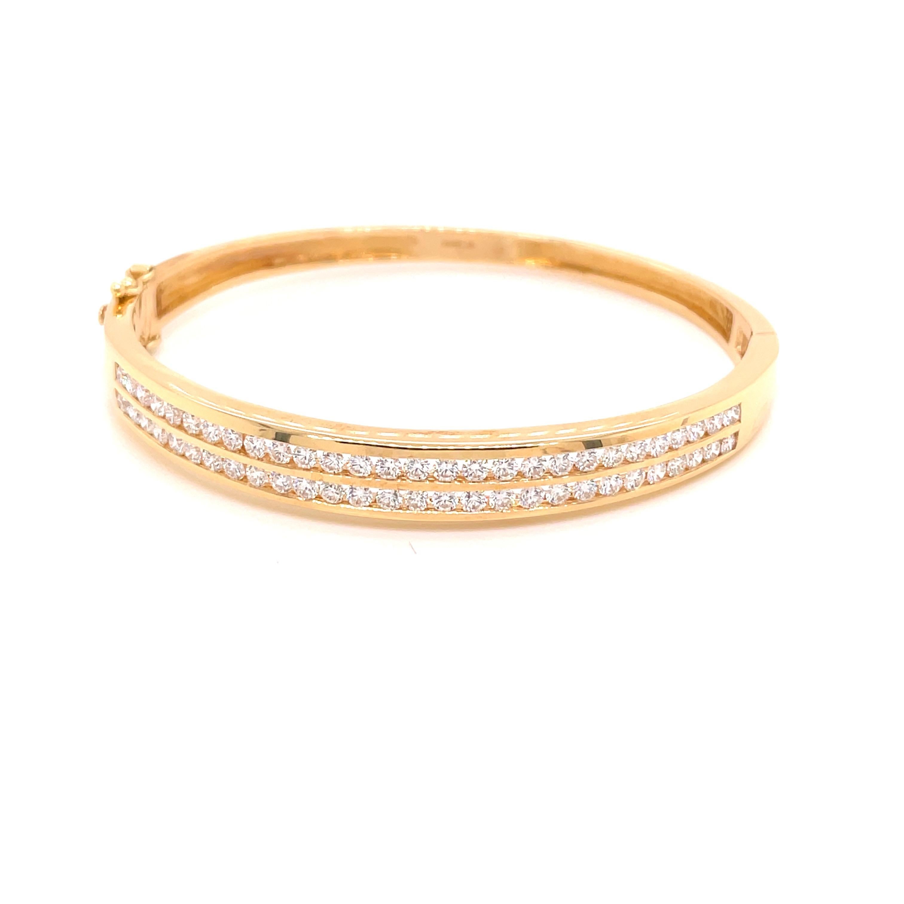 14K Yellow Gold Double Row Channel Diamond Bangle Bracelet 2.04ct - The bangle is set with 56 round brilliant diamonds weighing 2.04ct with G - H color and VS2 clarity. The width of the bangle on top is 7mm and tapers to 4mm on the bottom. The