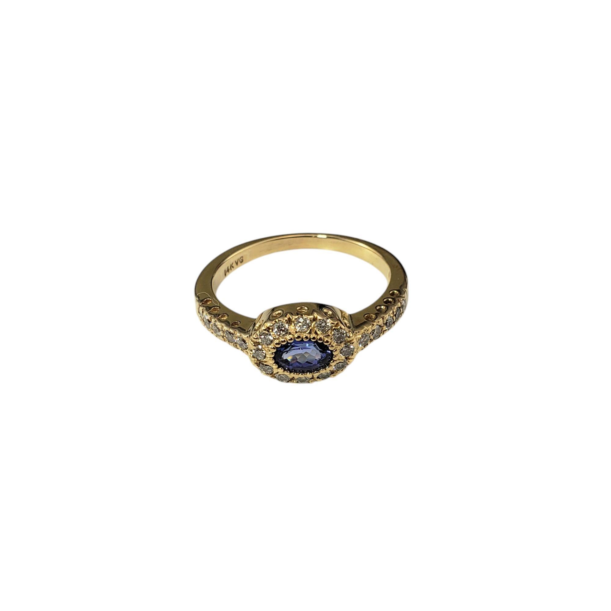 14K Yellow Gold Tanzanite and Diamond Halo Ring Size 8 JAGi Certified-

This stunning 14K yellow gold ring features one oval tanzanite stone that is set horizontally across the band, giving the ring a contemporary and distinctive look. Surrounding