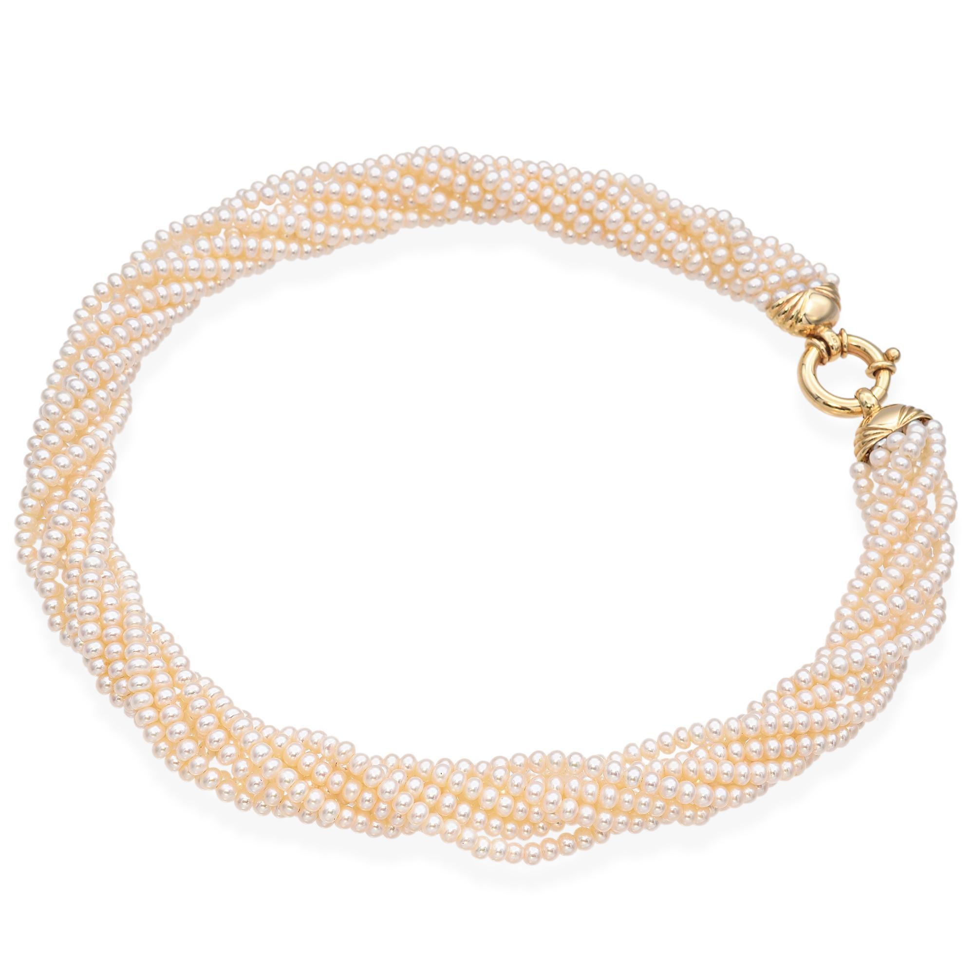 A stunning pearl necklace. It features multiple strands of cultured pearls, intricately twisted to create a luxurious and elegant design. The pearls are complemented by 14k yellow gold accents, adding a touch of warmth and sophistication. The