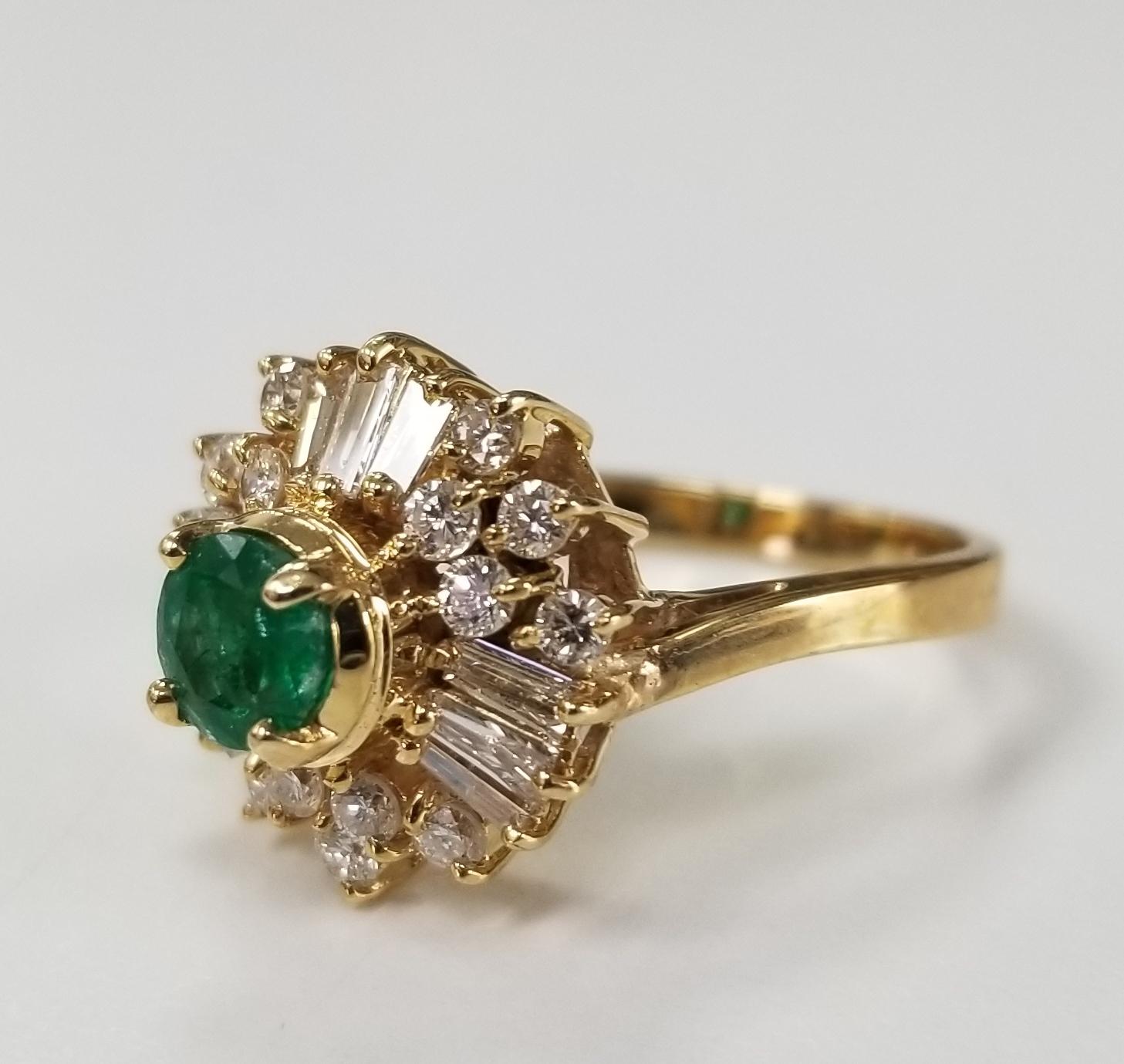 14k yellow gold emerald and diamond ring, containing 1 round  emerald weighing .60pts. and 15 round full cut and 9 baguette diamonds  weighing  of very fine quality weighing 1.00pts.  This ring is a size 7 but we will size to fit for free.