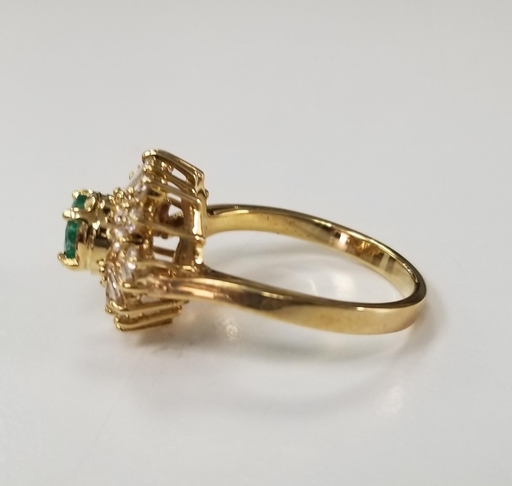 Contemporary 14 Karat Yellow Gold Emerald and Diamond Cluster Ring For Sale
