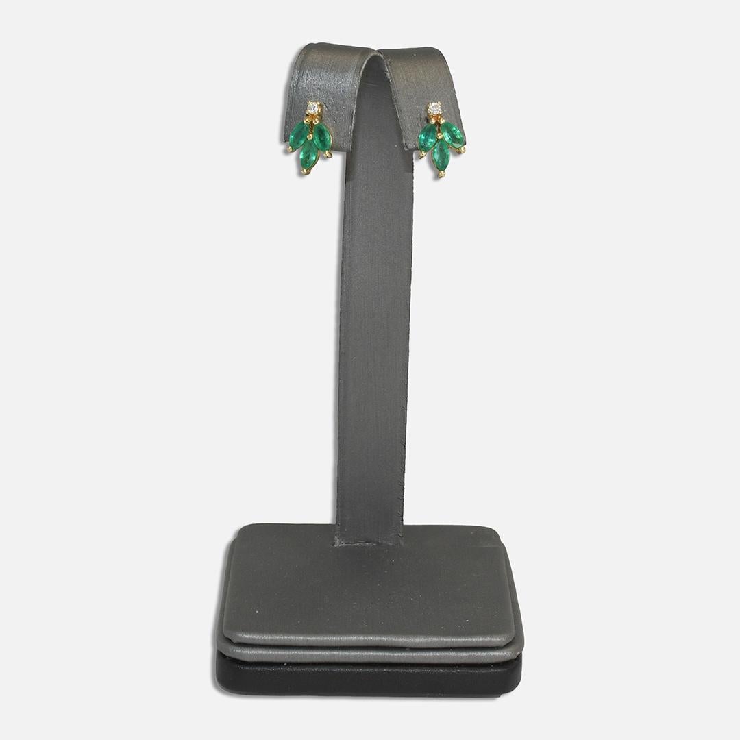 Emerald and diamond earrings in 14k yellow gold settings.
The settings are 14k and the posts test 10k gold.
The natural emeralds are marquise shape and have a very nice color, 1.00 total carats.
The are two small, round brilliant cut diamonds, .08
