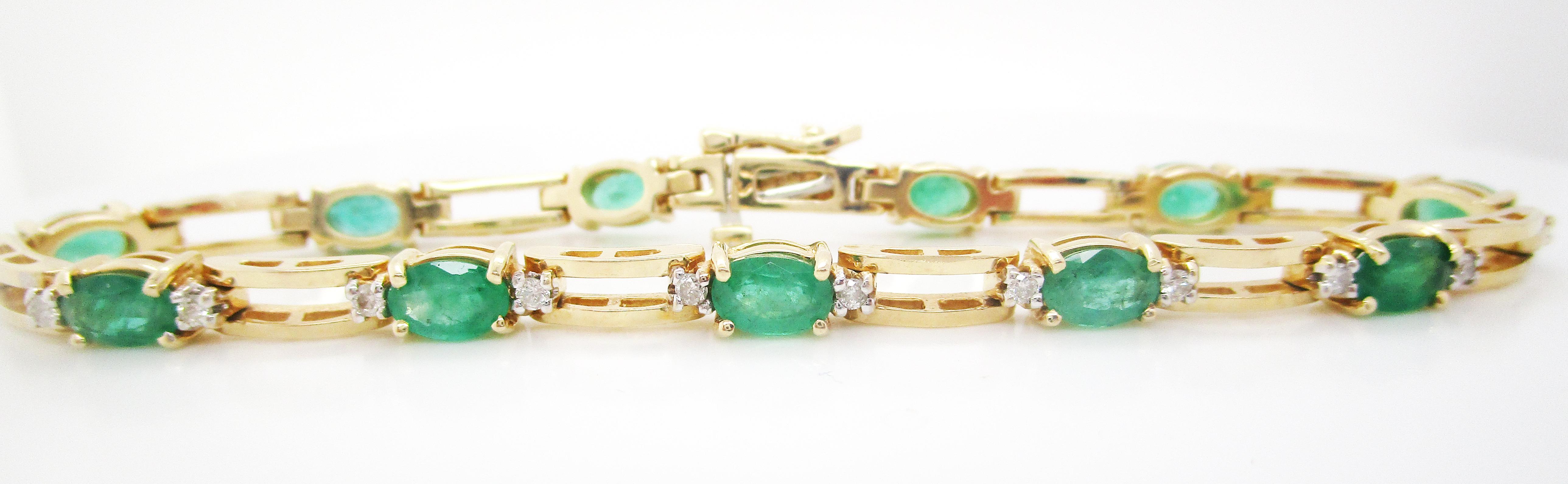 This is a gorgeous mid-century bracelet featuring a stunning selection of emeralds and diamonds in a classic straight line look! The combination of warm yellow gold, rich green emeralds, and bright white diamonds is striking and beautiful! This