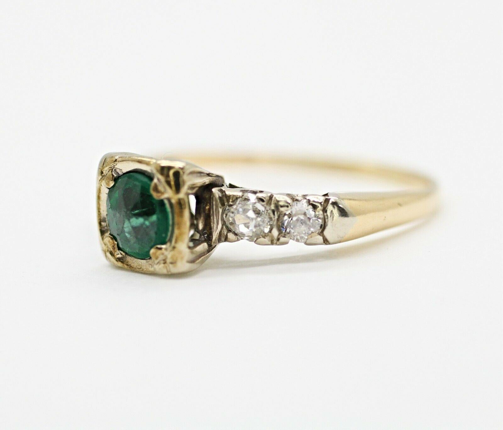  14k yellow gold emerald and diamond ring containing 
Specifications:
    main stone: 5.mm  round EMERALD OLD CUT 
    diamonds: 4 PIECES ROUND DIAMONDS
    carat total weight: 0.26
    color: H
    clarity: SI2
    brand: UNBRANDED
    metal: 14K