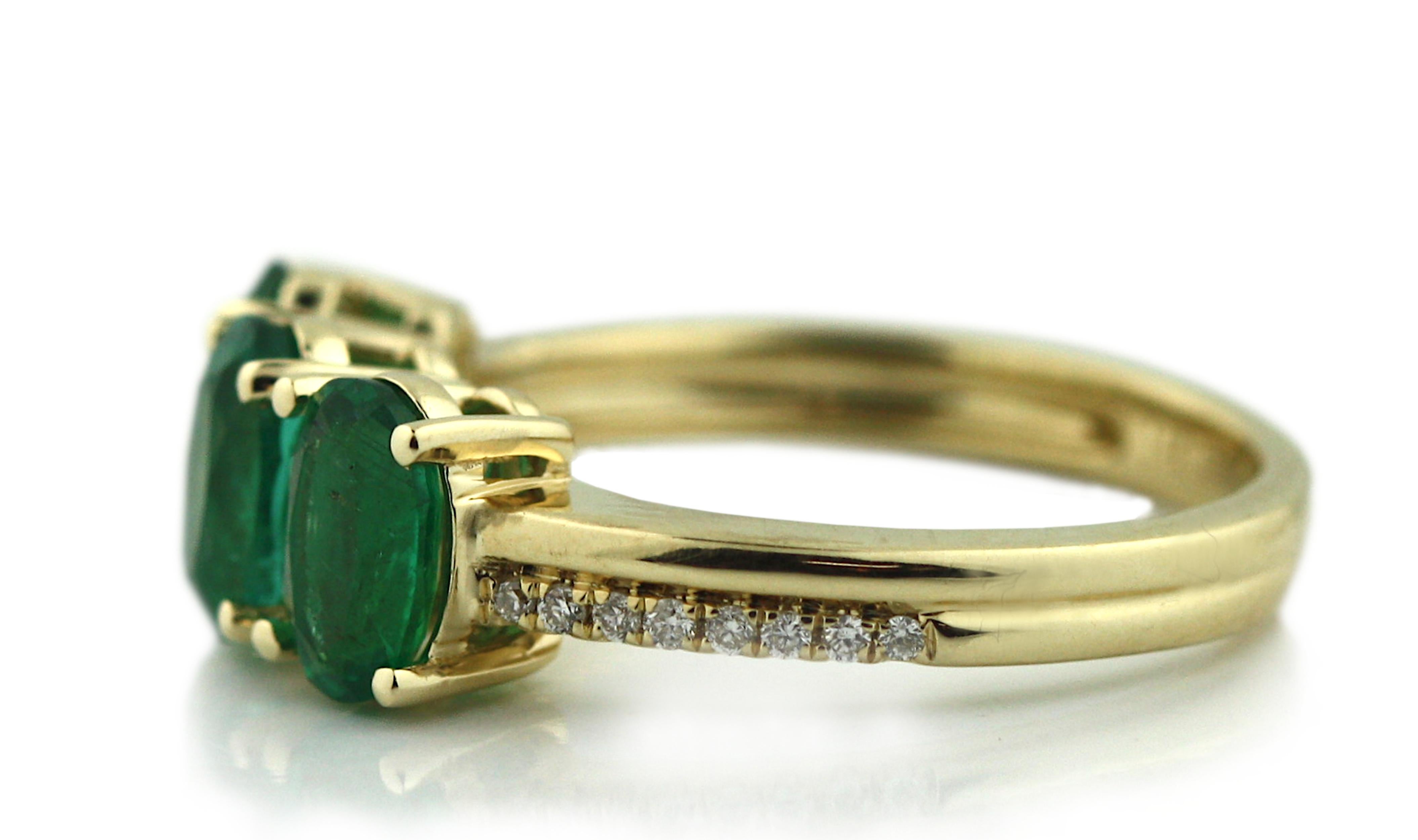 14K Yellow Gold Emerald and Diamond Ring 
Composed of three oval, brilliant cut Emeralds 
weighing 2.16 cts., measuring 6.98 x 4.91 x 2.99 mm to 7.06 x 5.0 x 3.90 mm
within a surround of sixteen diamonds