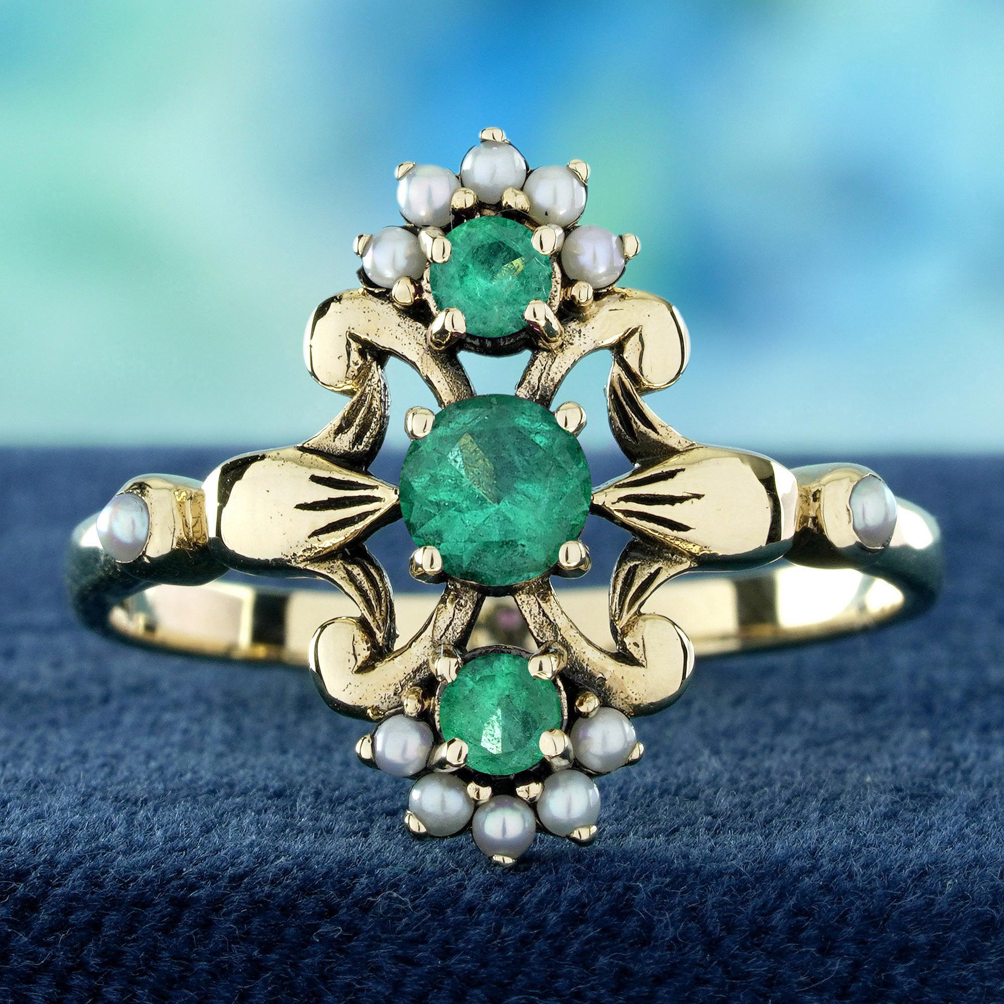 Three vibrant emeralds form a striking vertical line at the heart of this vintage-style floral ring, radiating rich, verdant color. Opals crown both the top and bottom, their soft, iridescent glow framing the emeralds like delicate petals. Intricate