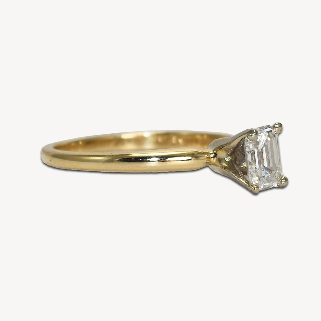 Diamond solitaire ring in 14k yellow gold setting.
Stamped 14k and weighs 2 grams.
The diamond is rectangle shape, step cut, .45 carats, G color, VS clarity.
The ring size is 6 and can be sized.
Like new condition.