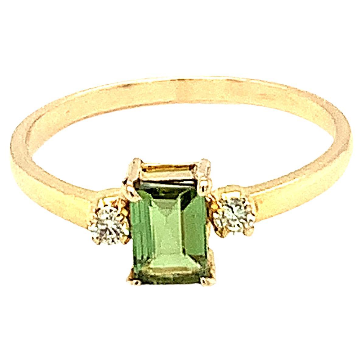 This simple and chic design ring has an emerald cut green tourmaline as a center stone with accent diamonds on each sides. Hand crafted and perfect for daily use.