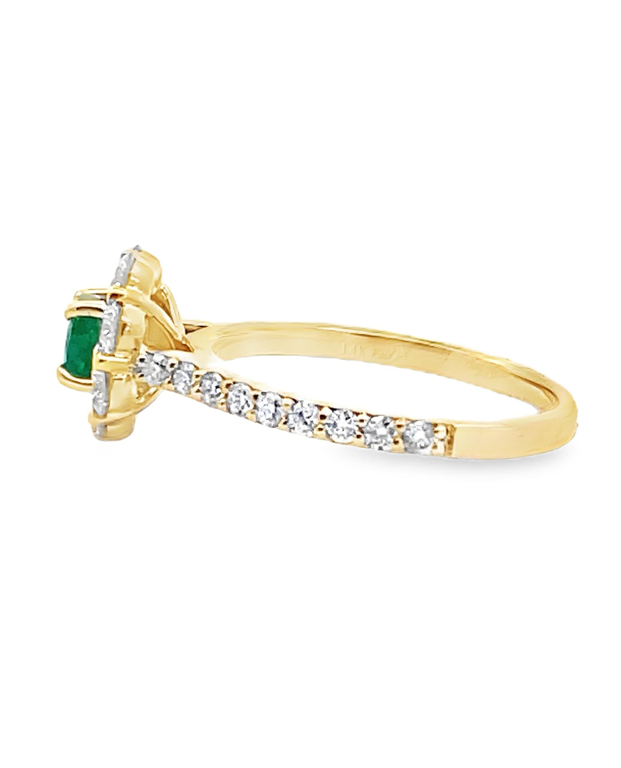 14K yellow gold ring with 8 round faceted diamonds weighing 0.69 carat total and on the band 18 round diamonds weighing 0.34 carat total.  In the center, one round faceted emerald weighing 1.03 carats.

- 2.97 grams
- Finger size 6.5
- Diamonds are
