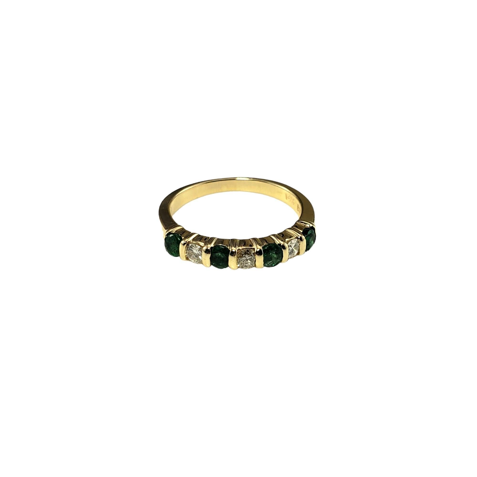 Vintage 14K Yellow Gold Emerald and Diamond Ring Size 5

This elegant band features three round brilliant cut diamonds and four round emeralds set in classic 14K yellow gold.  Width: 3 mm.

Total emerald weight: .28 ct.

Total diamond weight: .15