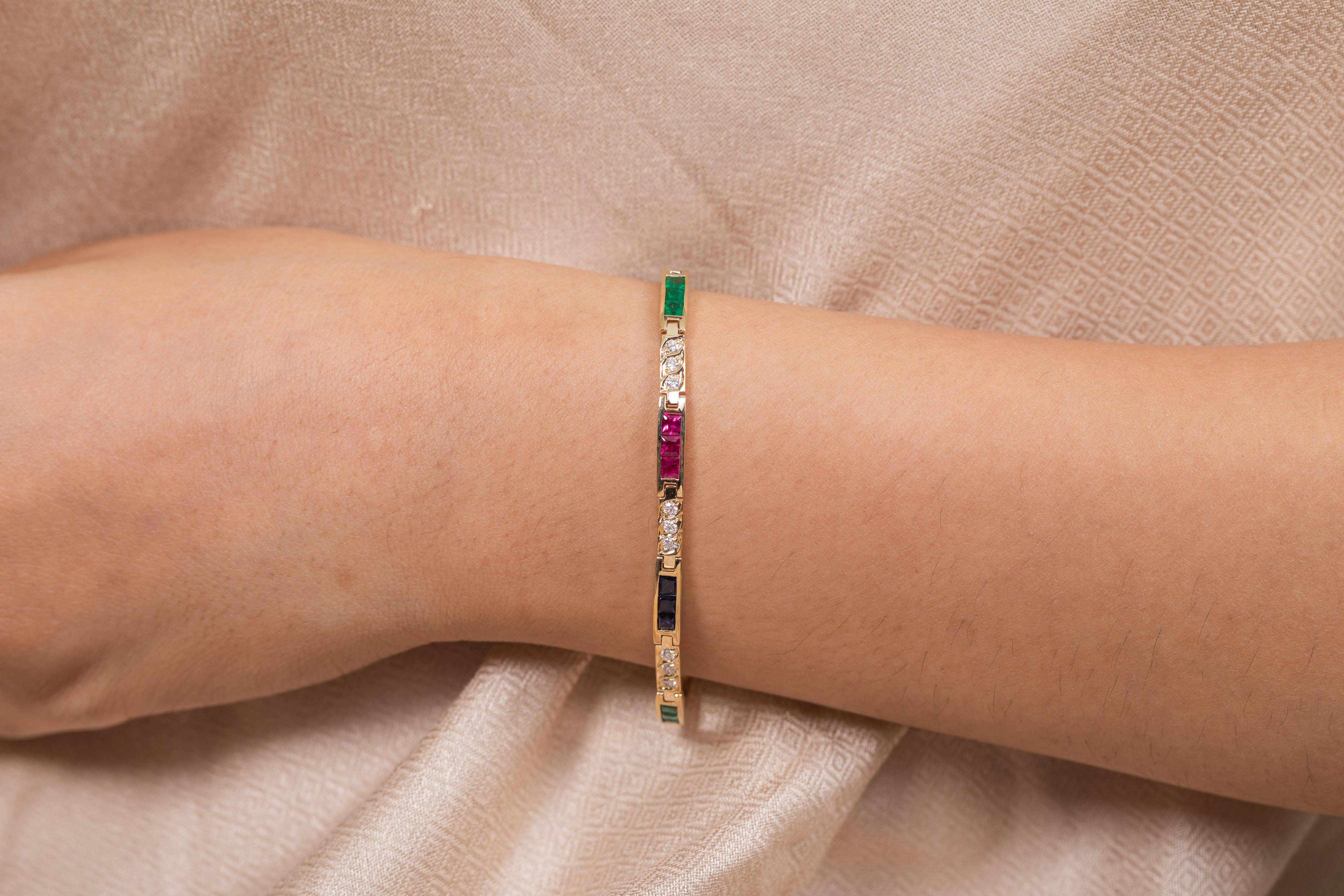 The wearing of charms may have begun as a form of amulet or talisman to ward off evil spirits or bad luck.
This emerald , ruby , blue sapphire bracelet has a square cut gemstone and diamonds in 18K Gold. A perfect piece of jewelry to adorn your
