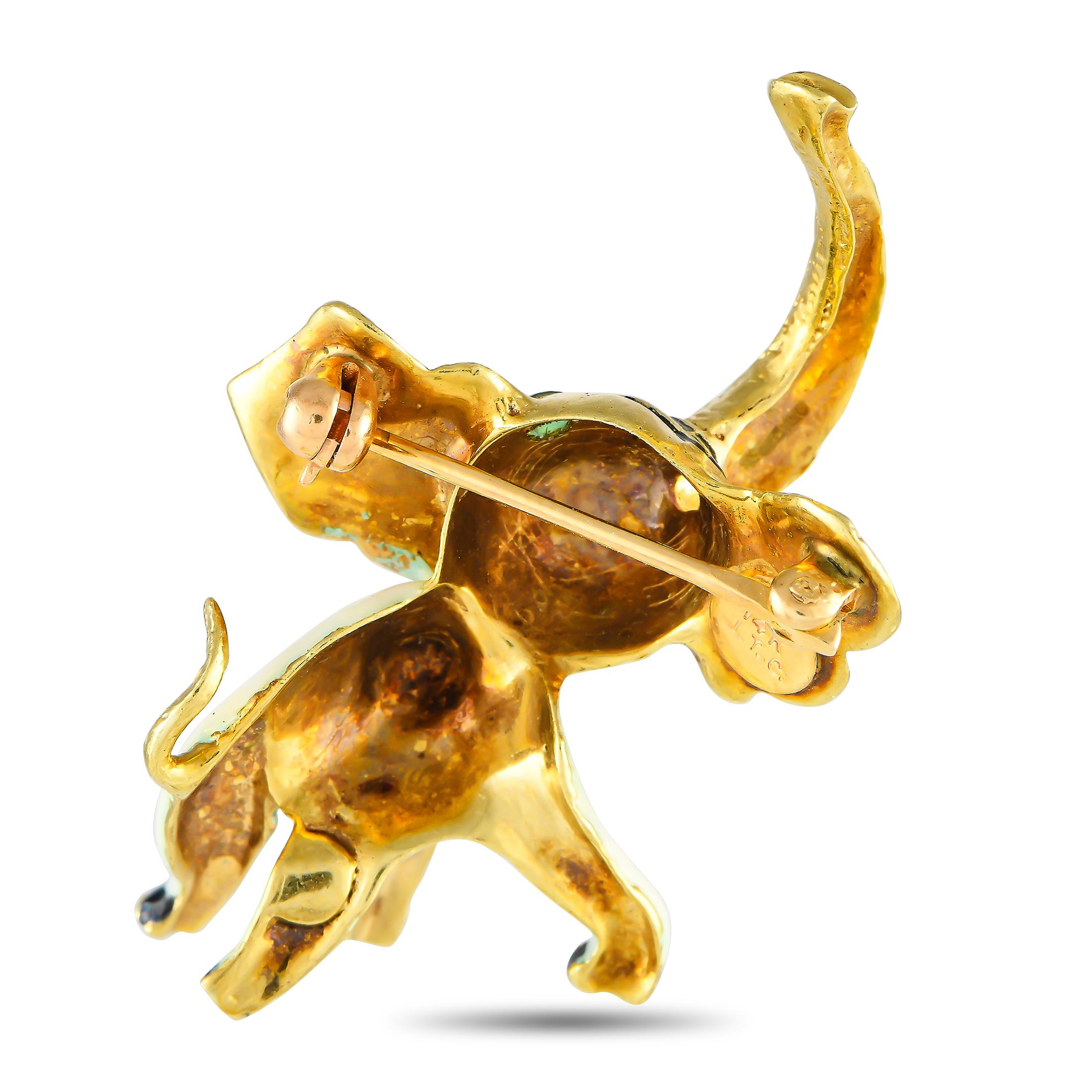 Add a whimsical dimension to a perfectly tailored suit with this three-dimensional brooch in 14K yellow gold. It features a sculpted elephant with fully textured head, ears, trunk, and tail, a white enameled body, and black enameled feet.This 14K