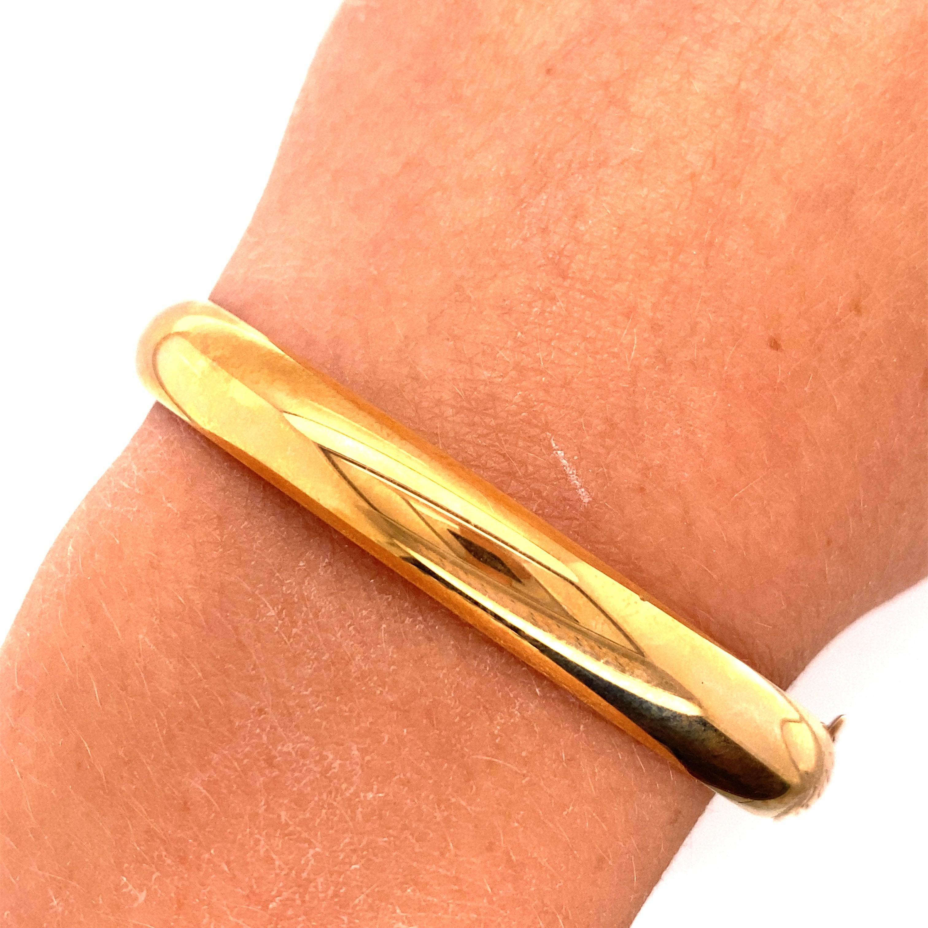 14K Yellow Gold Engraved Bangle Bracelet - The bracelet is 8mm wide. The inside diameter is 2.12 inches high and 2.35 inches wide and fits a standard size wrist. The bangle weighs 9.48 grams.