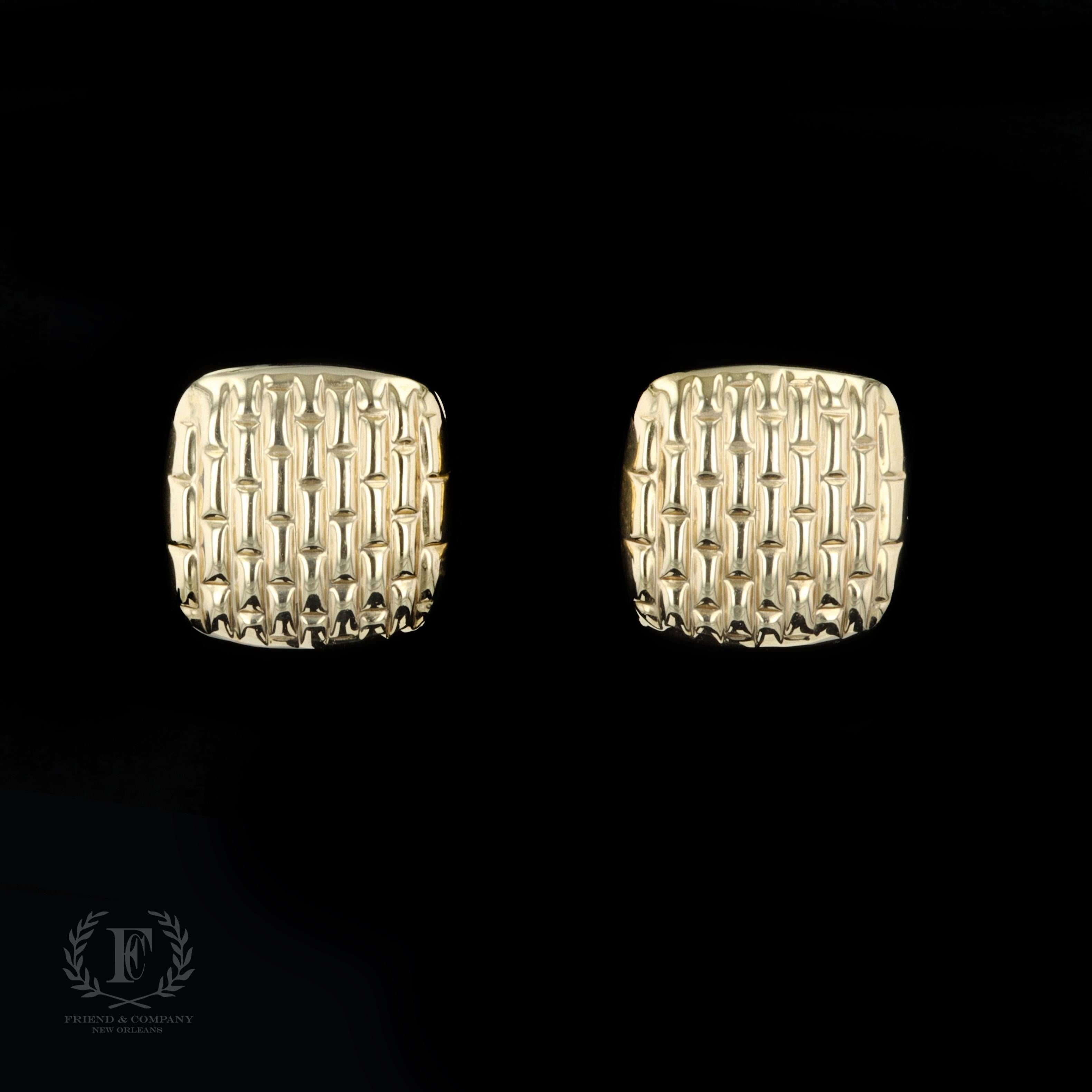 This pair of 14 karat yellow gold hollow brick motif estate earrings will add elegance to any outfit. The earrings feature omega clip backs and a striking raised design.