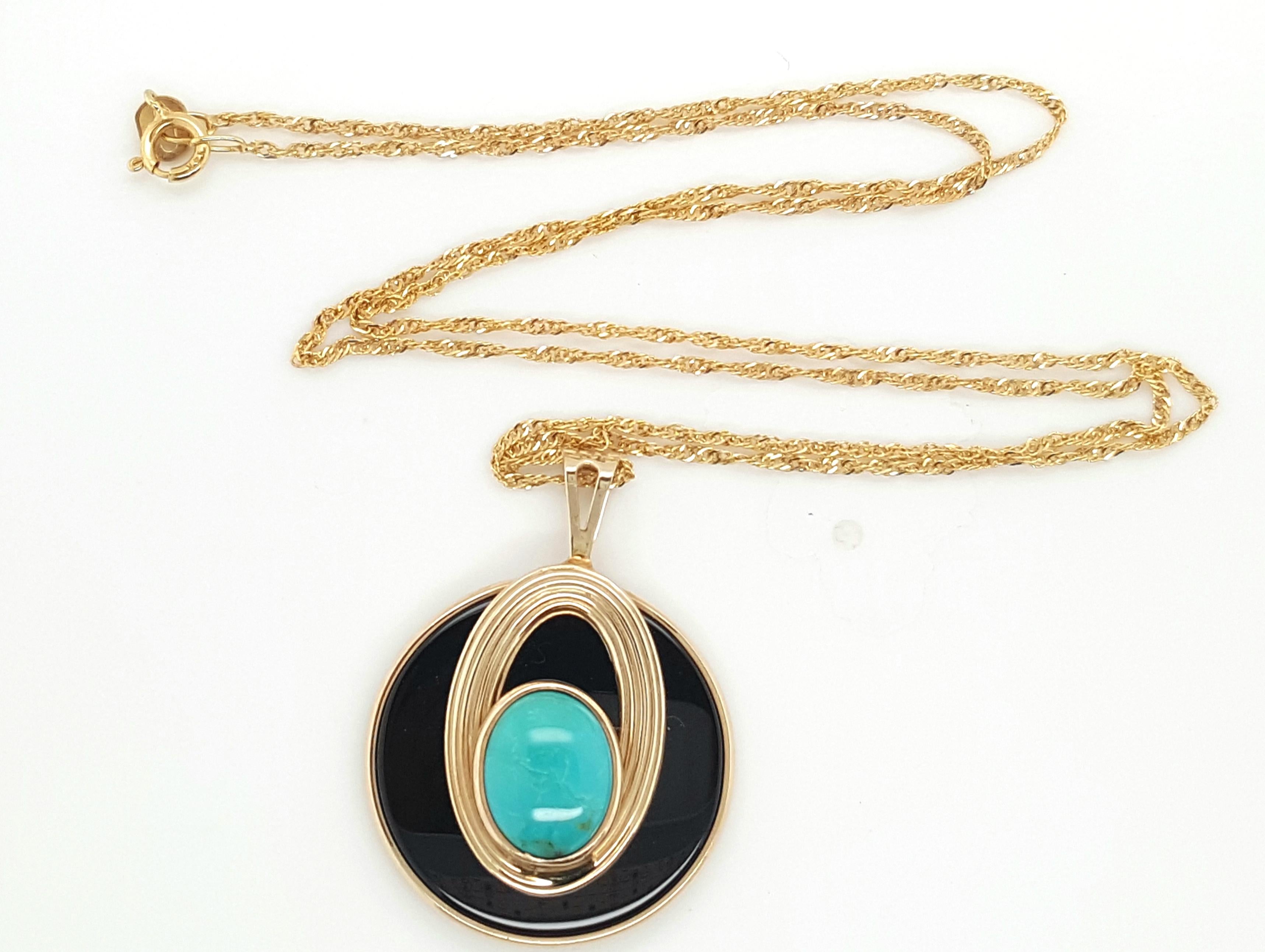  14K Yellow Gold Estate Onyx Disk Topped with Howlite Pendant and Chain.  The eye-catching pendant features an onyx disk bezel set and topped by an oval cabochon howlite surrounded by a ribbed gold bezel, completed by a tapered bail suspended by a