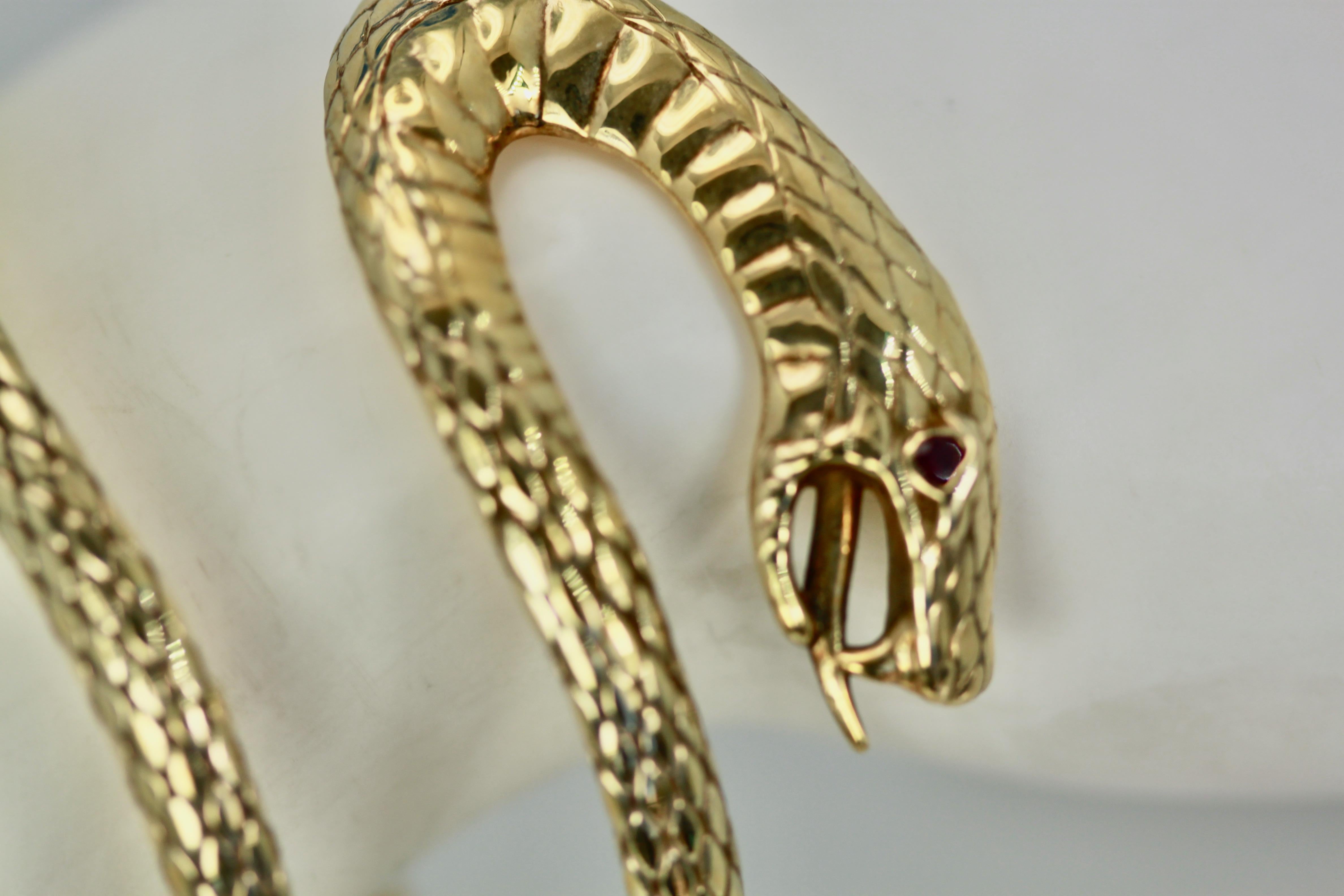 This amazing snake bracelet is completely detailed and engraved. It is attributed to Stephen Webster. Because of its unusual shape it fits many wrist sizes and is truly unique.  This snake has a ruby eye and fangs and tongue and wraps around the