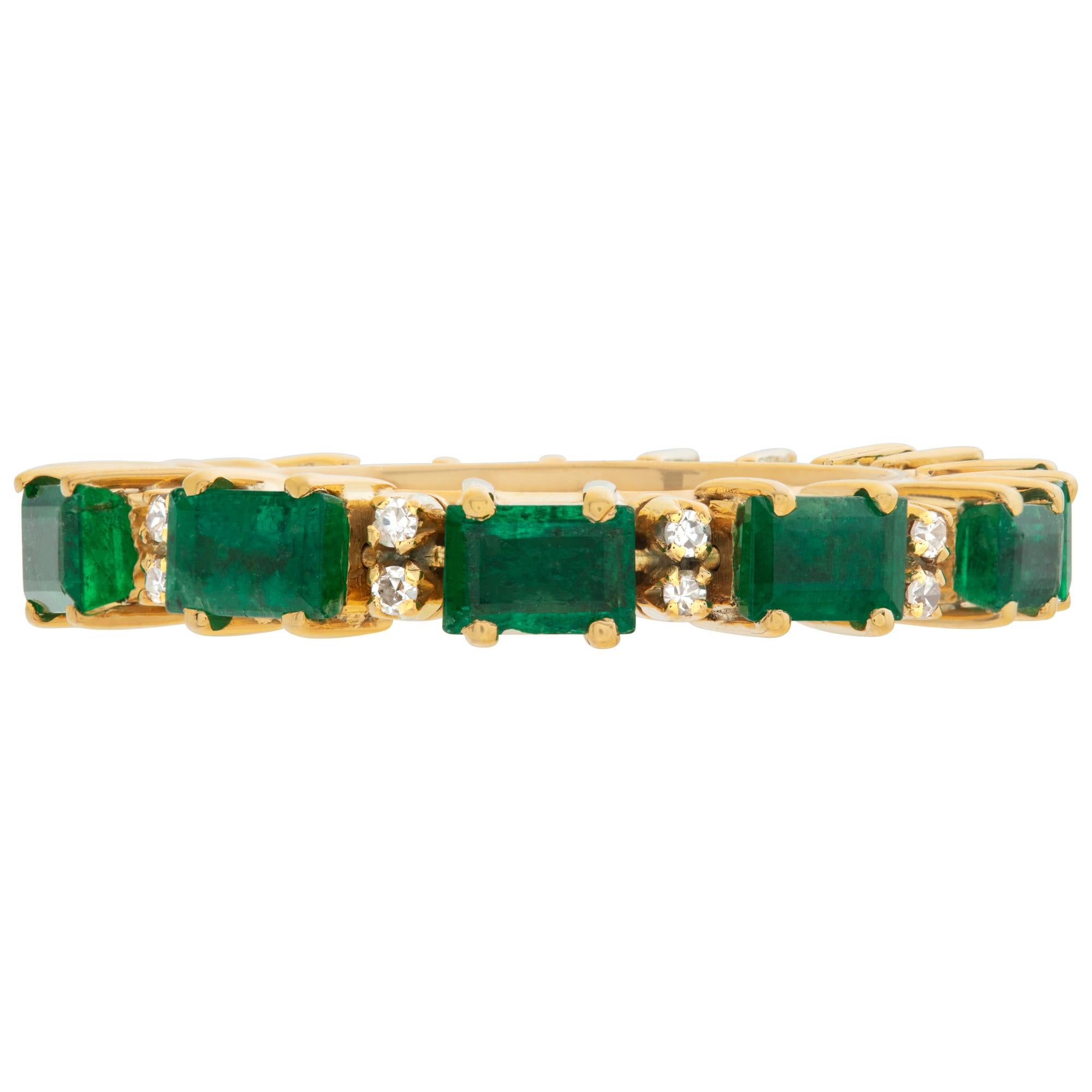 Eternity band with emeralds & diamonds set in 14k yellow goild. Emeralds total approx. weight: 2.20 carats. Diamonds total approx weight: 0.50 carat, estimate: G-H color, VS clarity.  Size 7This Diamond/Emerald ring is currently size 7 and some