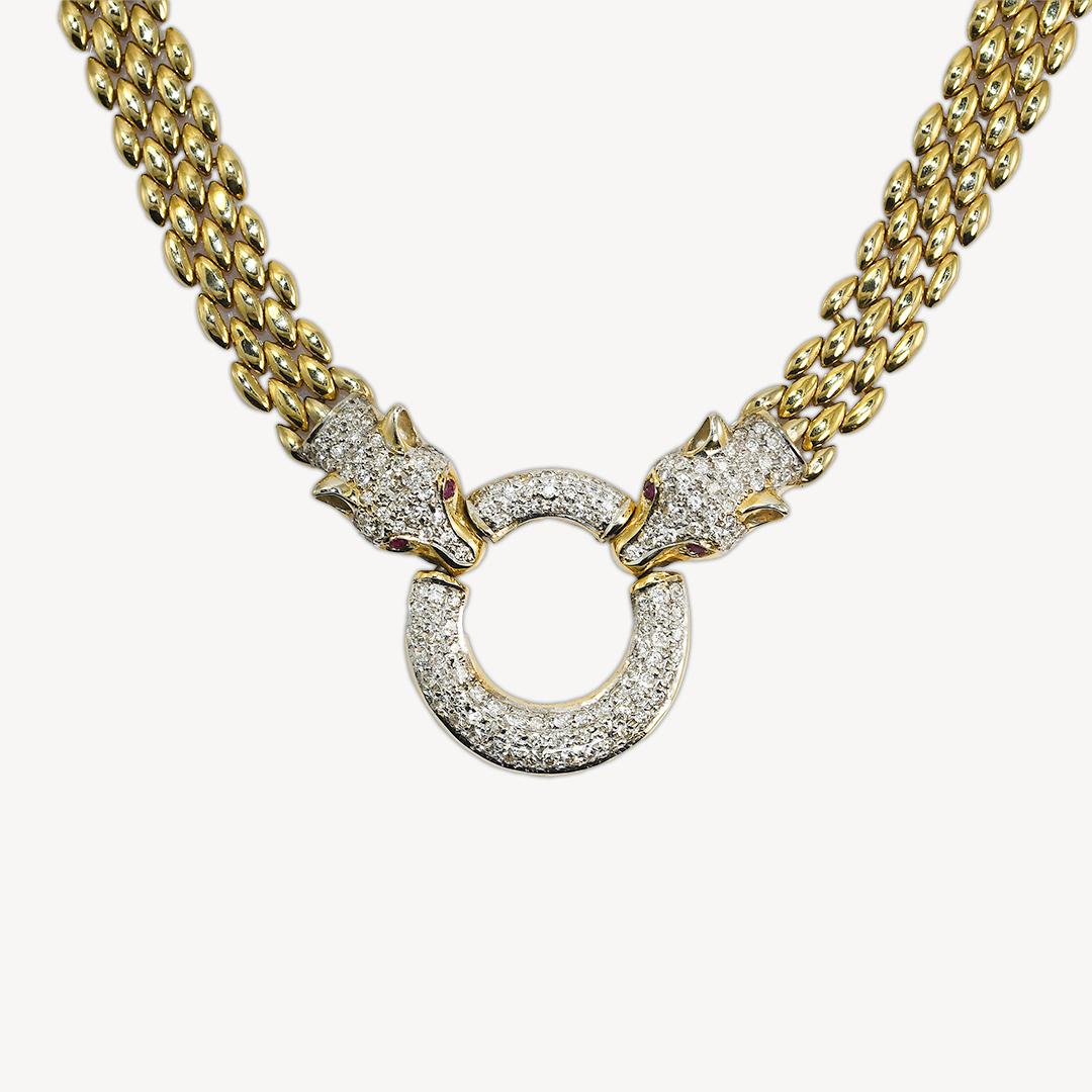 14k yellow gold and diamond panther necklace.
Stamped 14k and weighs 61.9 grams.
The diamonds in the pendant are round brilliant cuts, 1.50 total carats, J to K color, and Si to i1 clarity.
There are small rubies in the panther's eyes.
The flexible