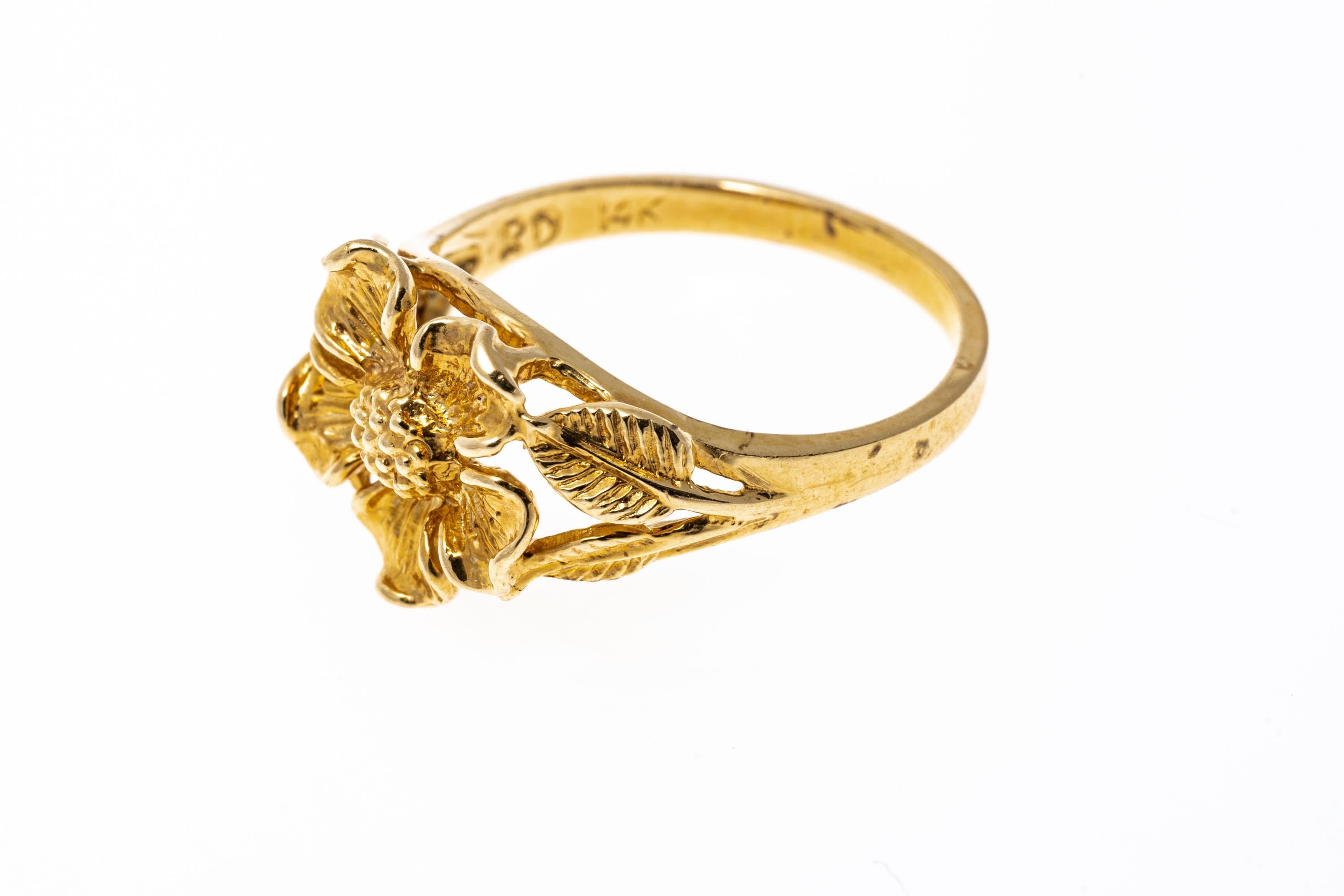 14k yellow gold ring. This pretty ring is a figural five petal flower motif, decorated with leaf patterned split shoulders.
Marks: 14k
Dimensions: 5/8