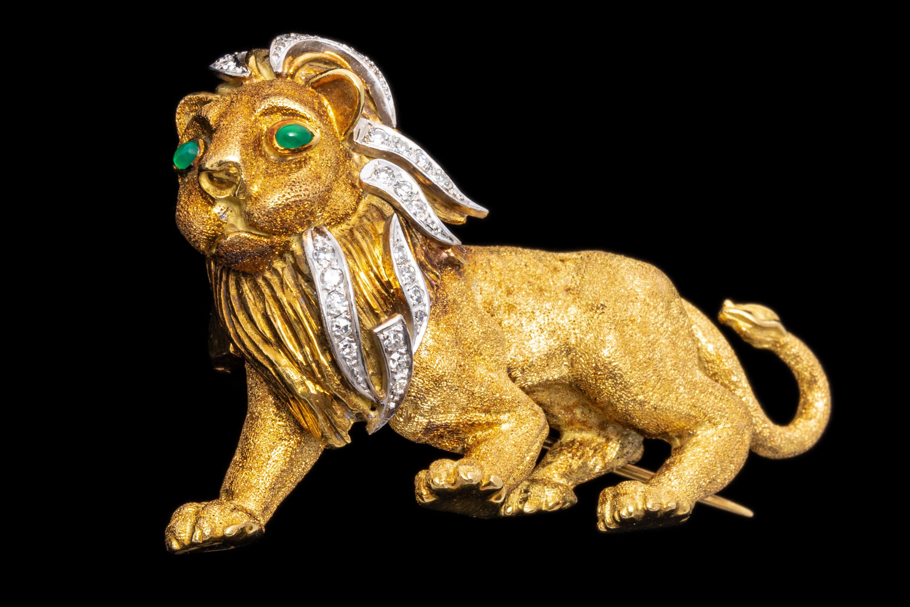 14k yellow gold brooch. This wonderful brooch is a stalking lion profile, matte sandblasted finished and decorated throughout the flowing mane, set with round faceted diamonds, approximately 0.21 TCW. The brooch is finished with cabachon cut, medium