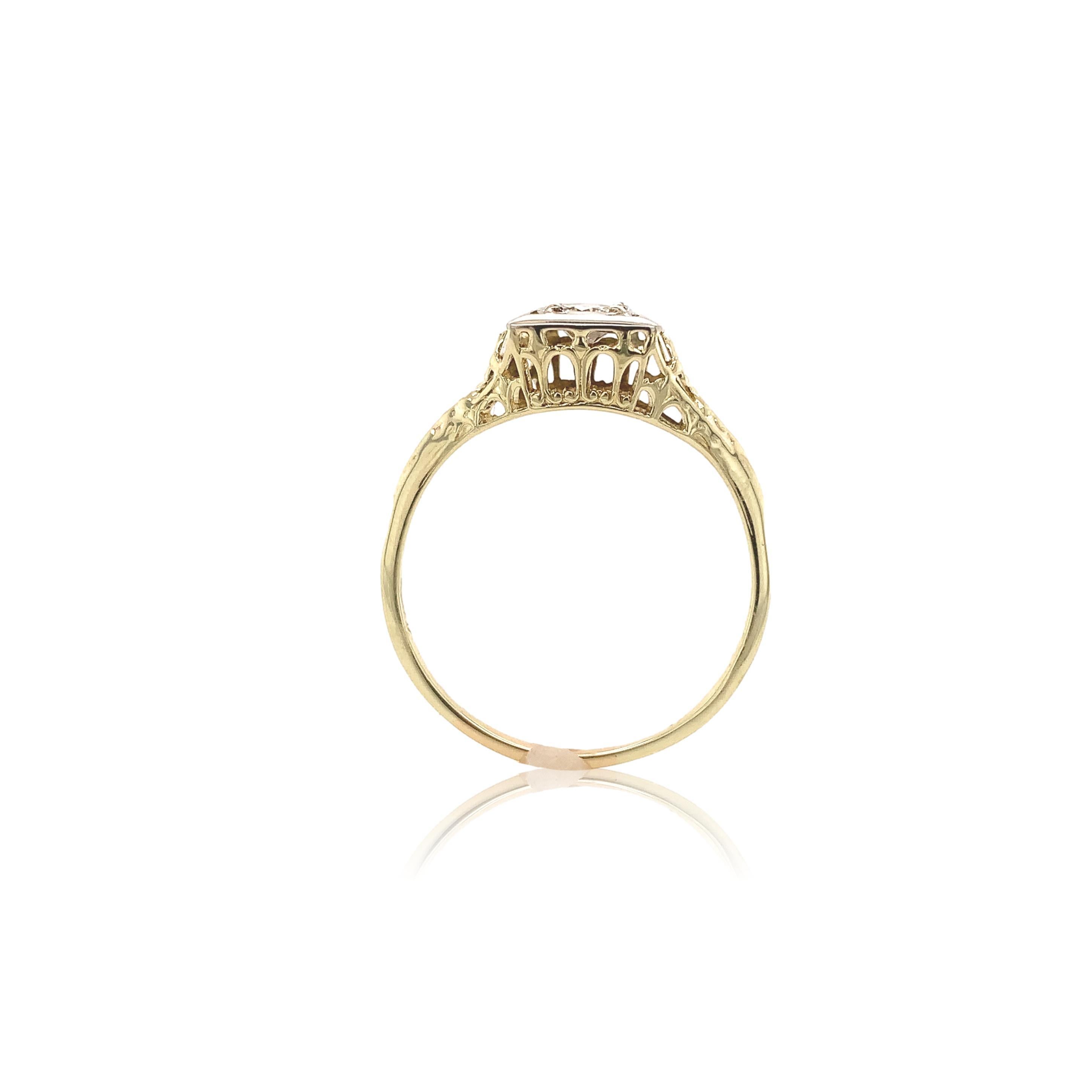 14K yellow gold filigree ring with a white gold top featuring a round brilliant cut diamond weighing .26cts. The diamond has SI clarity and champagne color. It measures about 4mm and has 4 new prongs. The ring fits a size 9.25 finger and weighs