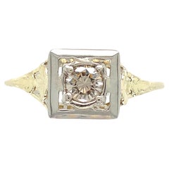 Vintage 14K yellow gold filigree ring with a white gold top featuring a round brilliant