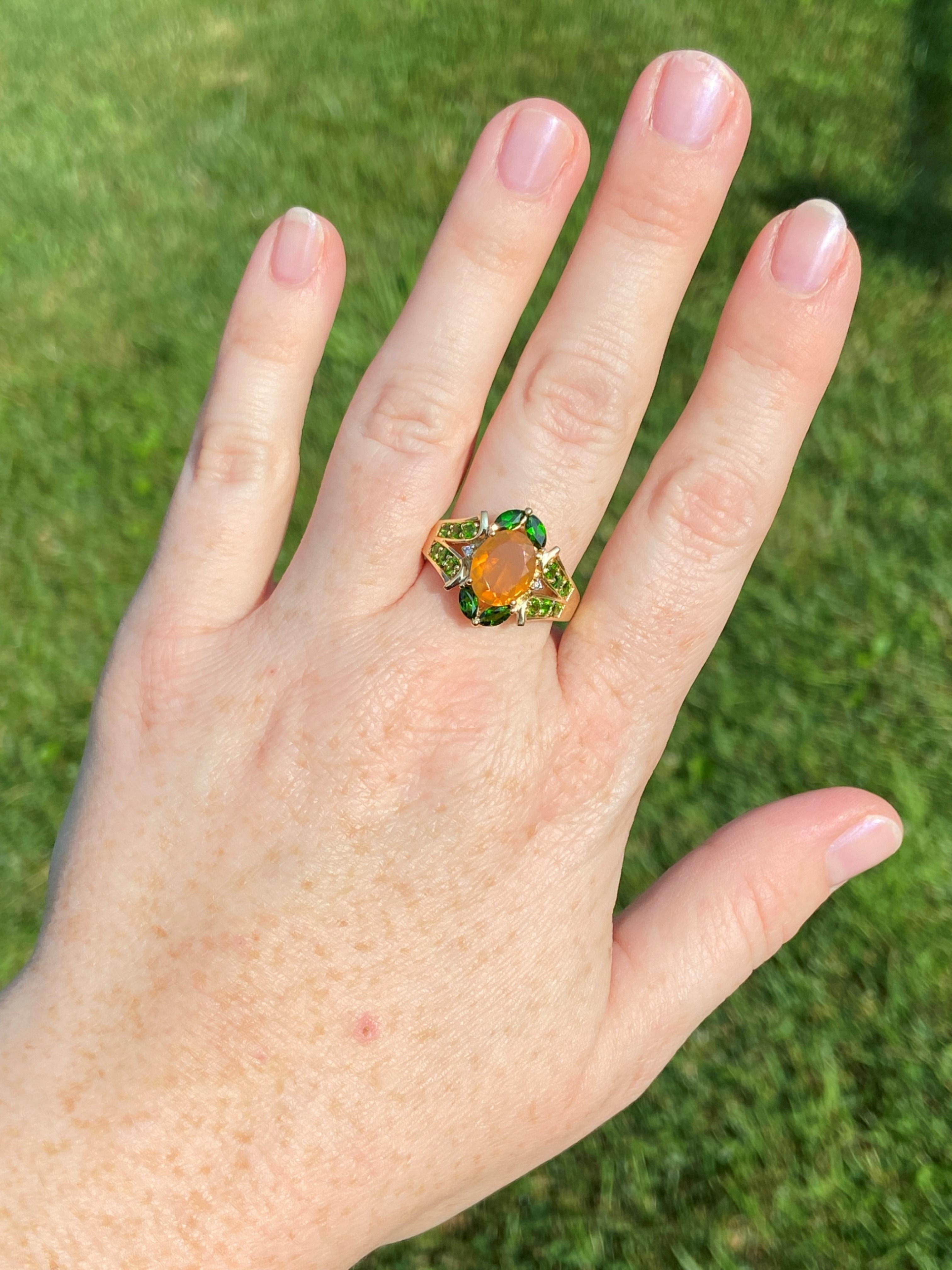 This ring features two lesser-seen but no less stunning gemstones: fire opal and tsavorite garnet. Fire opal is mostly mined in Mexico and is the more vibrant option for those with an October birthday. That watery look that fire opals have make them